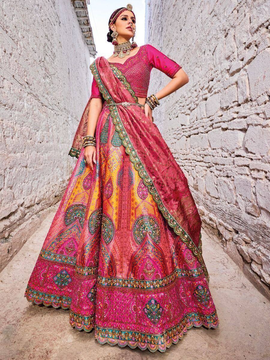 Pink designer lehenga choli with intricate embroidery, perfect for Indian weddings and festive occasions.