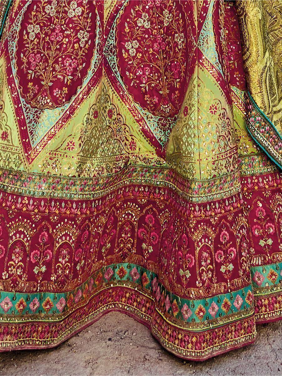 Designer lehenga choli with intricate floral embroidery in maroon, green, and gold tones