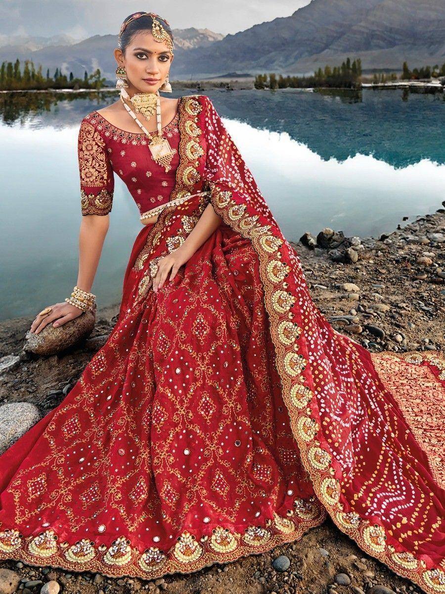Red designer lehenga choli with gold embroidery, perfect for Indian weddings and festive occasions.