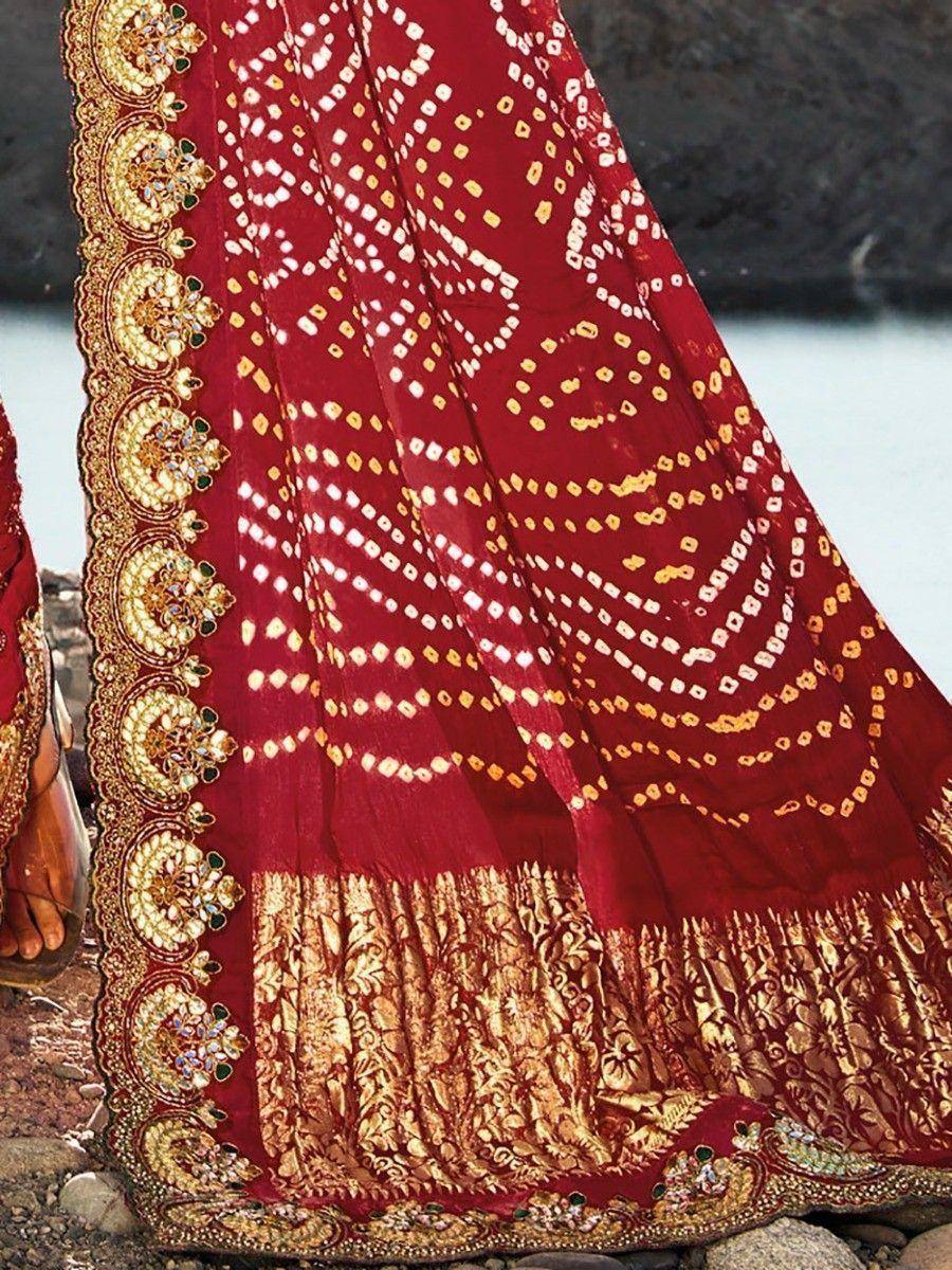 Red ethnic lehenga with gold embroidery and mirror work, perfect for Indian weddings and festivals.
