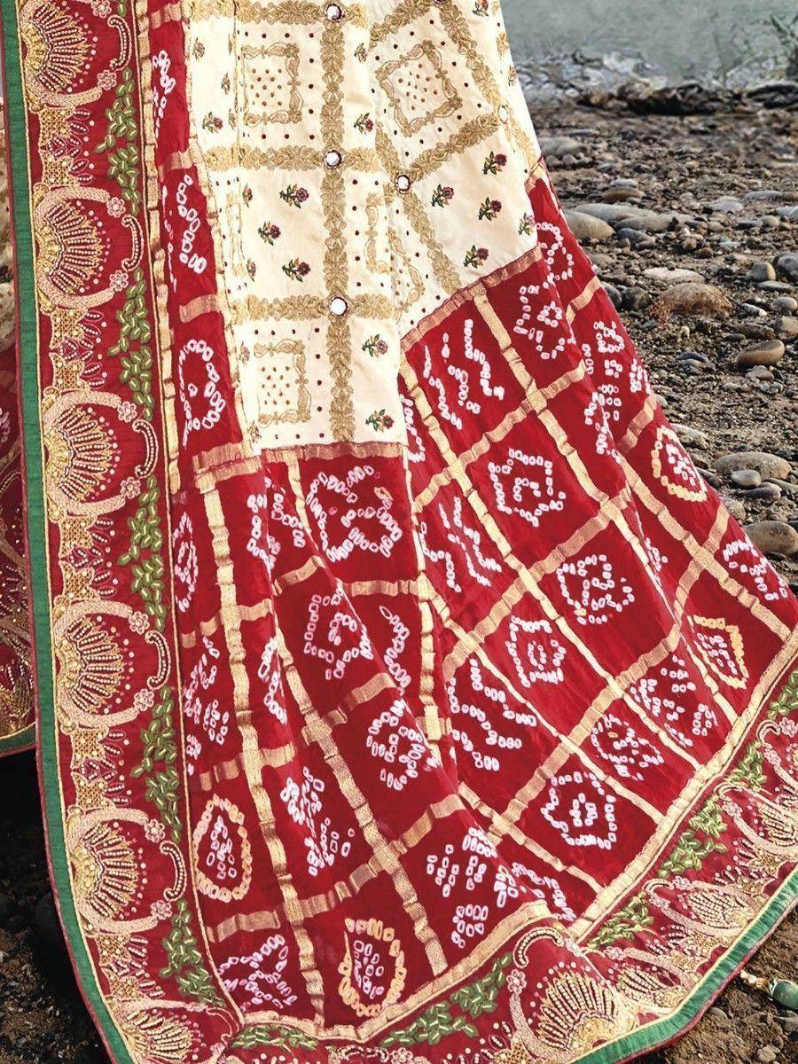 Red and cream embroidered lehenga with intricate gold patterns and floral motifs, perfect for Indian ethnic wear.