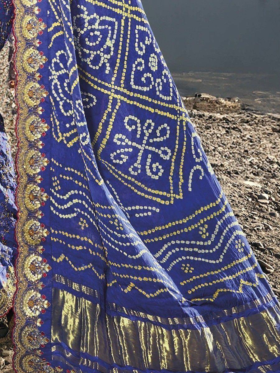 Blue ethnic lehenga with gold embroidery and mirror work, perfect for Indian weddings and festive occasions.