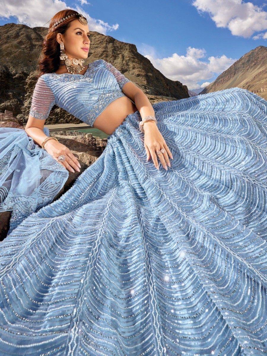 Elegant blue designer lehenga choli with intricate beadwork, perfect for Indian ethnic wear occasions.