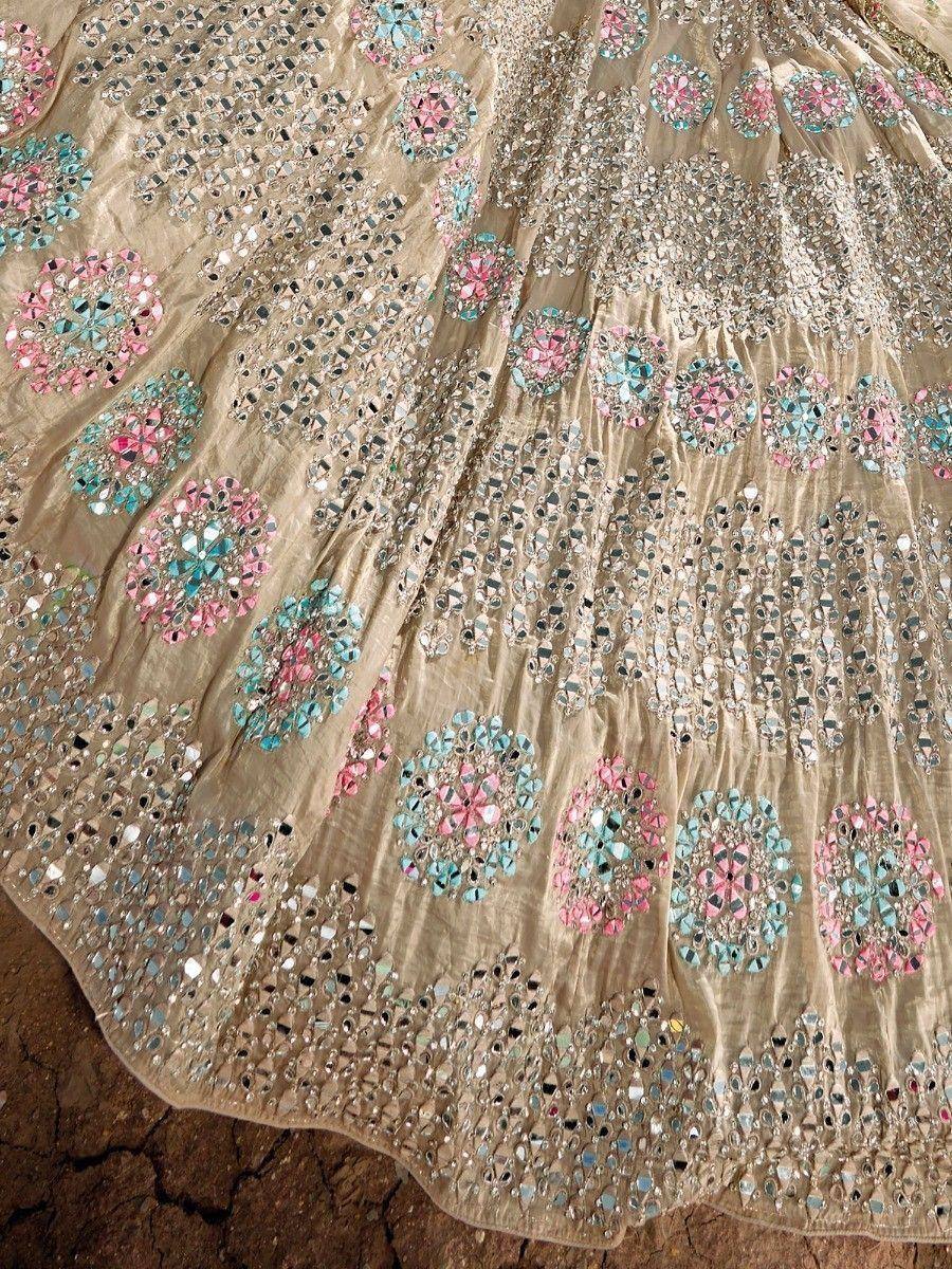 Designer lehenga with mirror work and floral embroidery in pink and blue on beige fabric