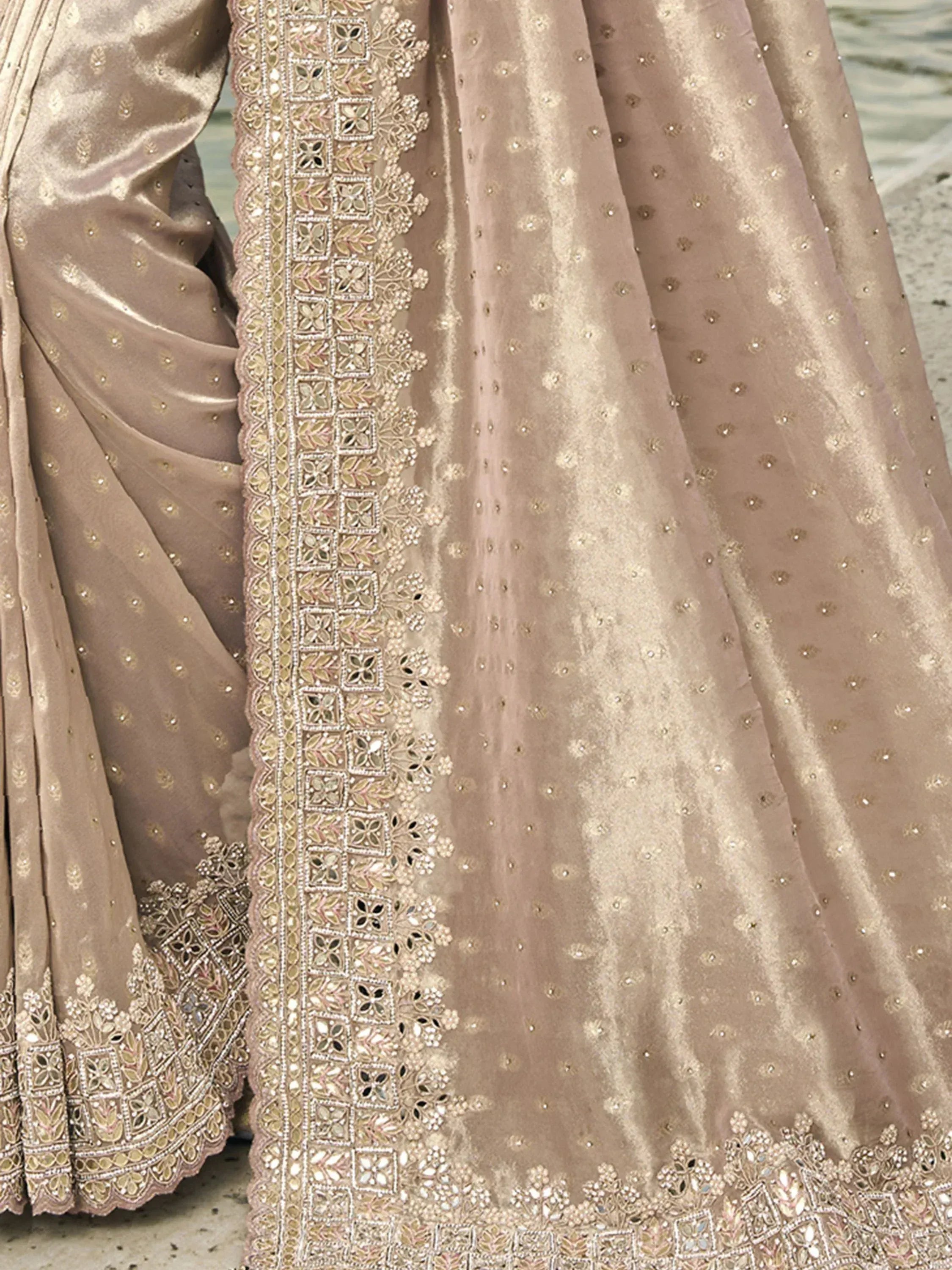 Elegant beige lehenga choli with intricate mirror and bead embroidery, perfect for Indian ethnic wear.