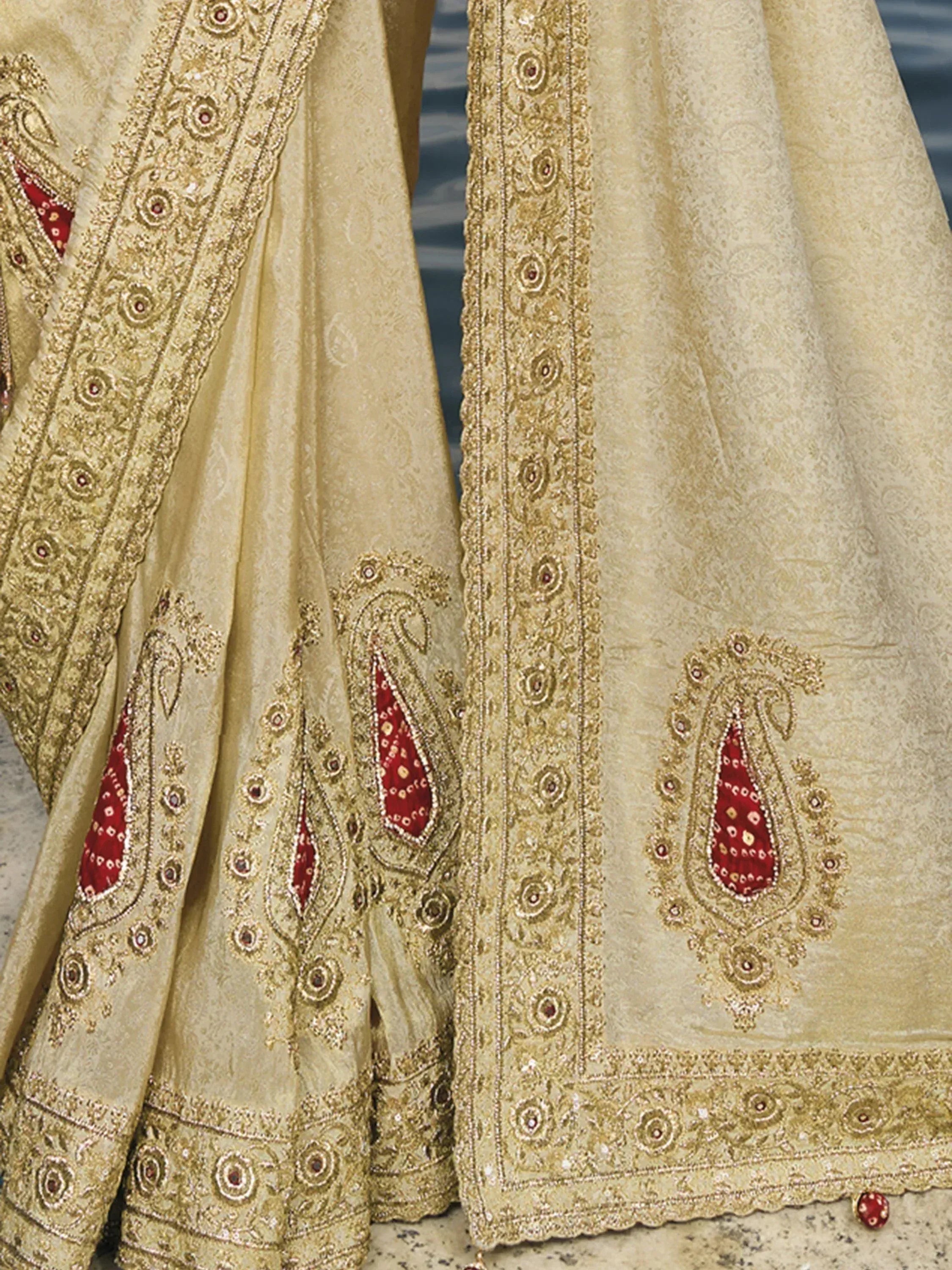 Beige designer lehenga with red paisley embroidery and gold detailing for Indian ethnic wear