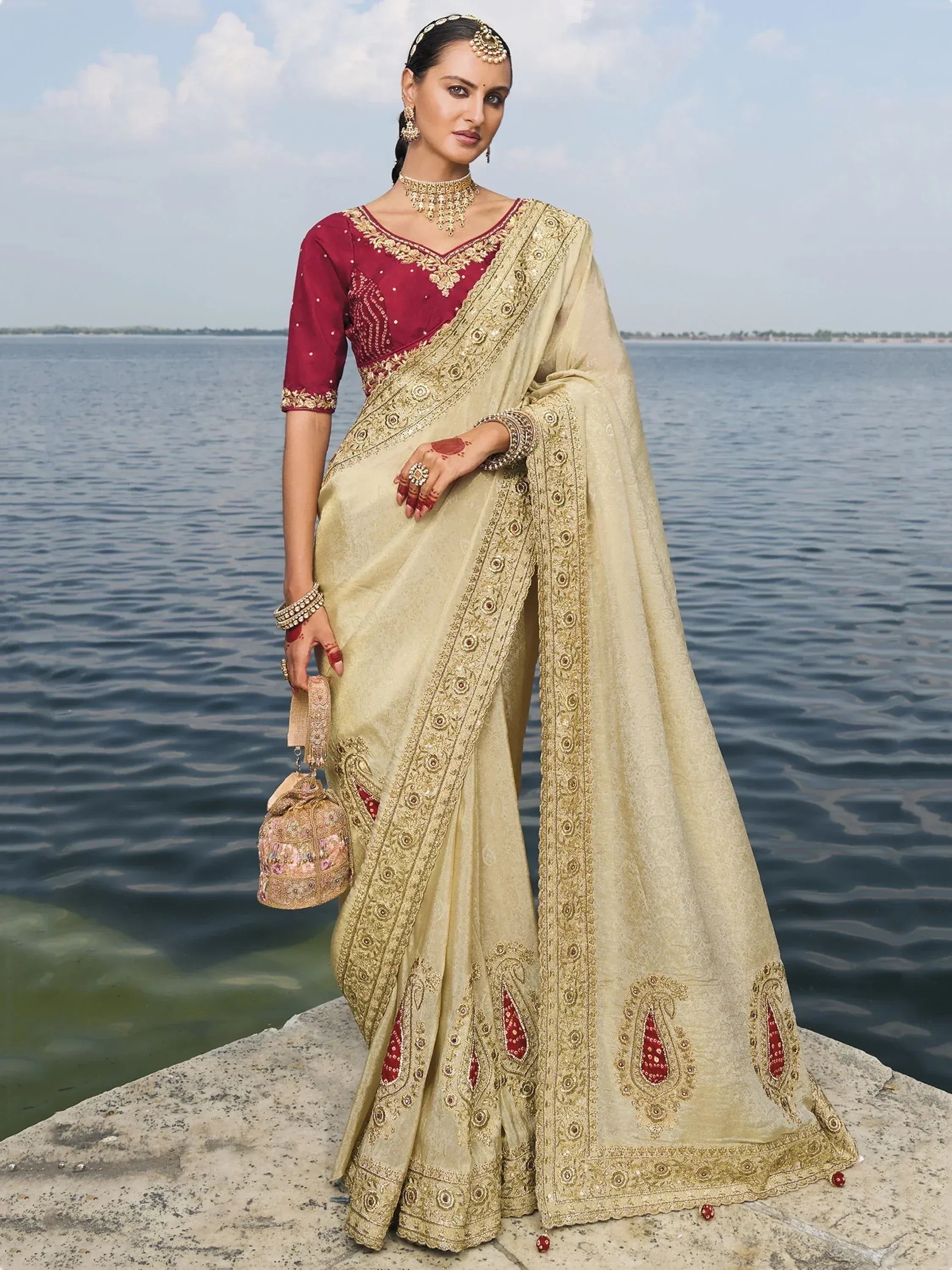 Elegant beige saree with gold embroidery and maroon blouse, perfect for Indian ethnic occasions