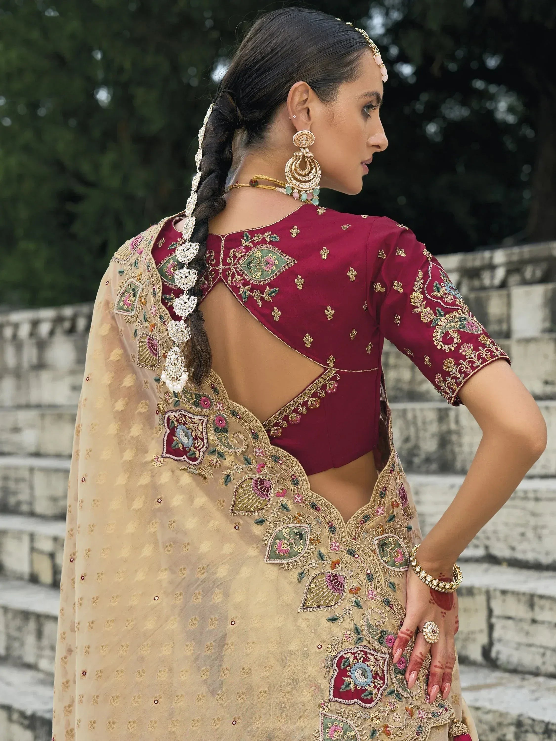 Maroon embroidered lehenga choli with gold detailing, sheer dupatta, and traditional jewelry for Indian ethnic wear