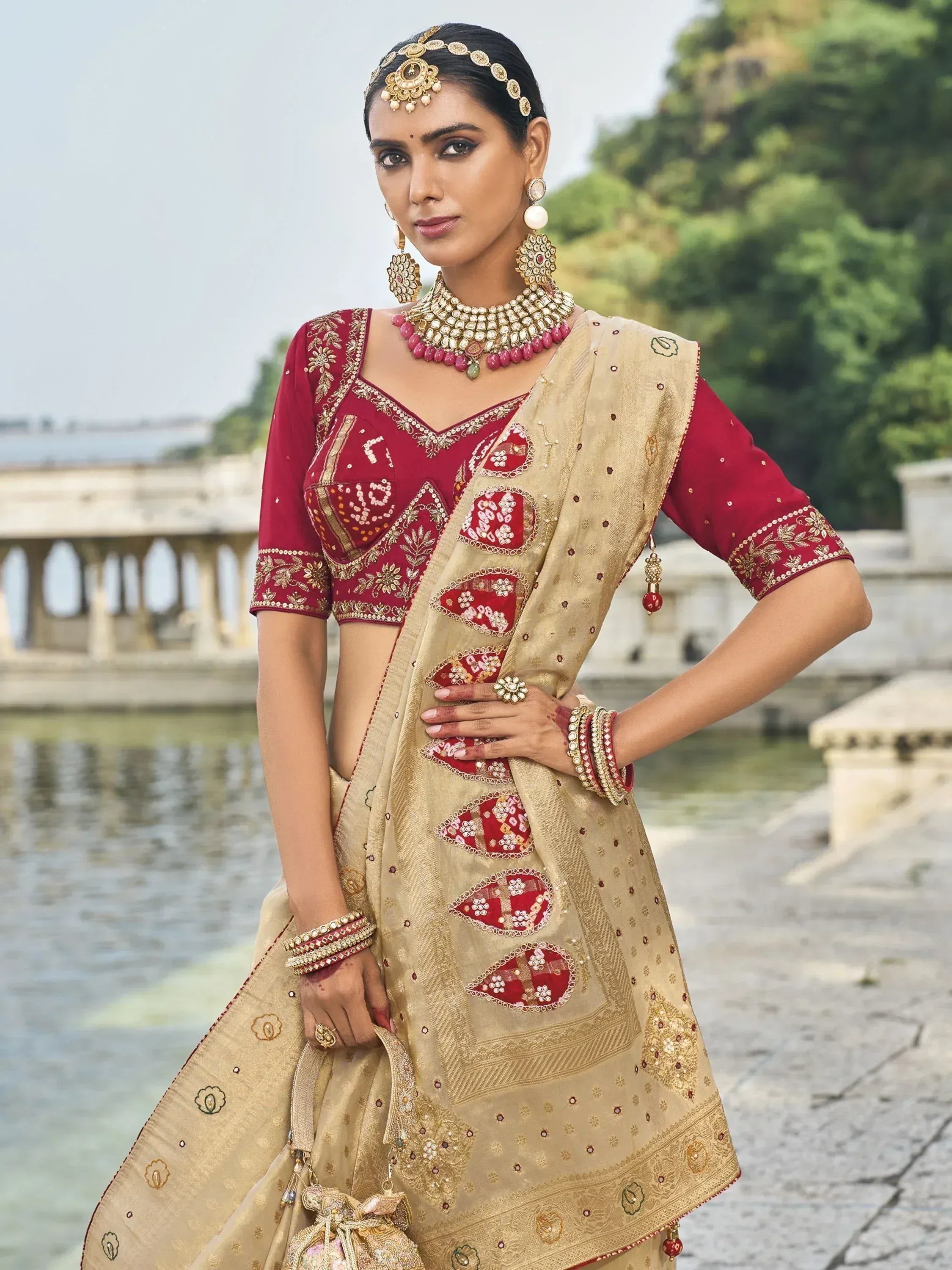 Elegant maroon and gold embroidered lehenga choli with traditional Indian jewelry, perfect for weddings and festive occasions.