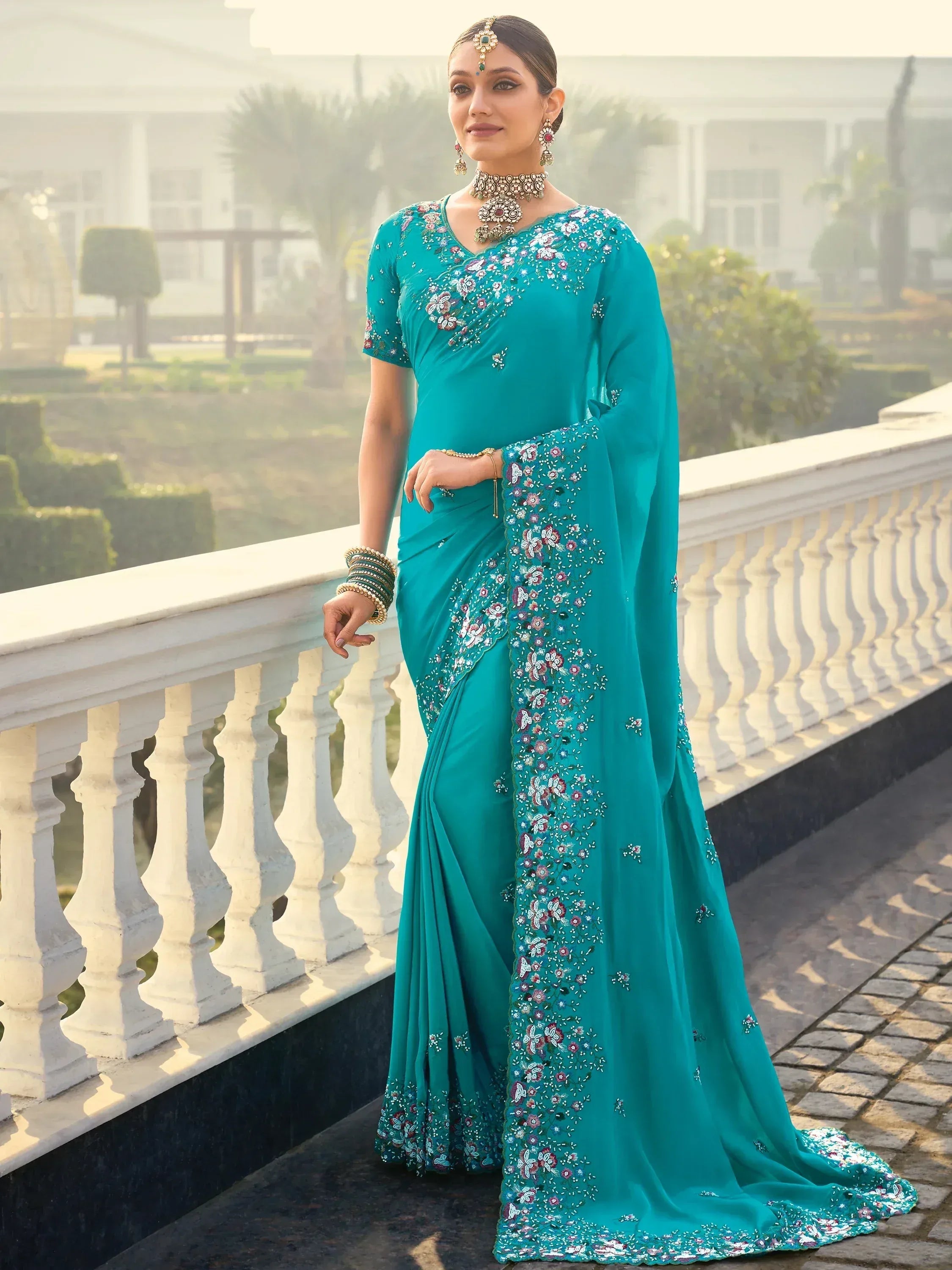 Teal embroidered saree with floral designs, perfect for Indian ethnic wear occasions.