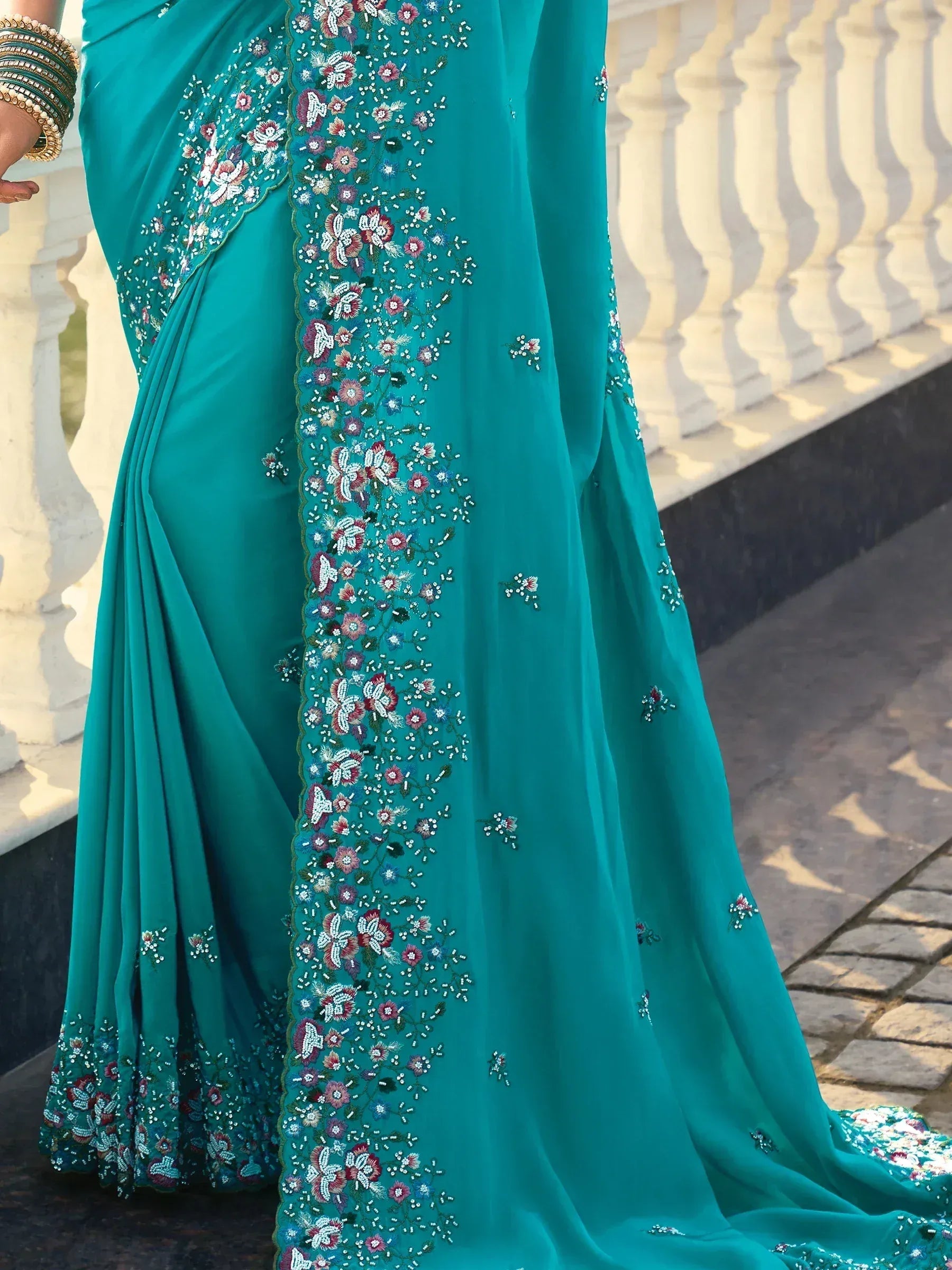 Teal saree with floral embroidery and beadwork, perfect for ethnic occasions