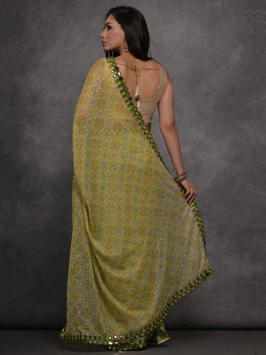 Green printed saree with sequin border, paired with backless blouse, ethnic Indian wear