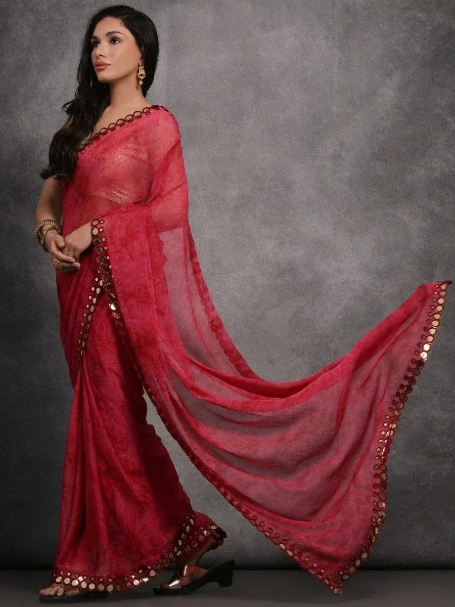 Red ethnic saree with mirror work and sheer pallu, styled for festive occasions