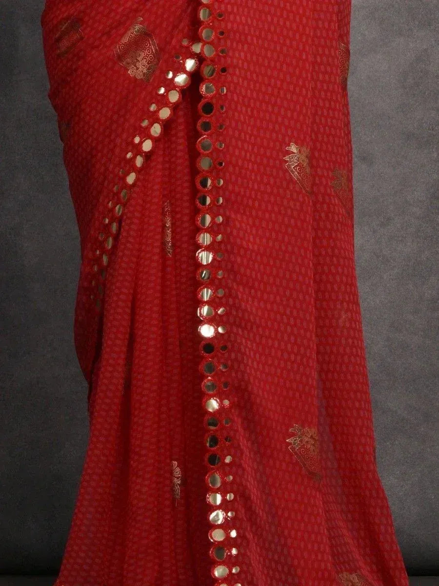 Red ethnic saree with mirror work and gold embroidery, perfect for festive occasions