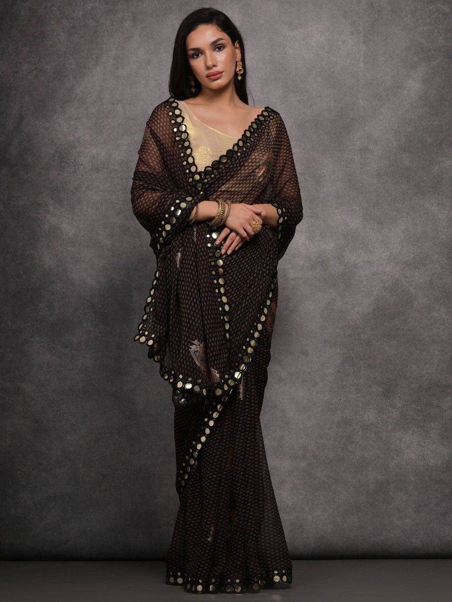 Elegant black saree with gold mirror work, paired with a golden blouse for festive occasions.