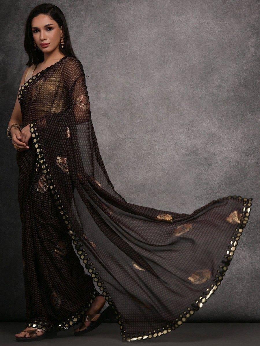 Elegant black saree with gold embellishments and sheer detailing, perfect for ethnic occasions.