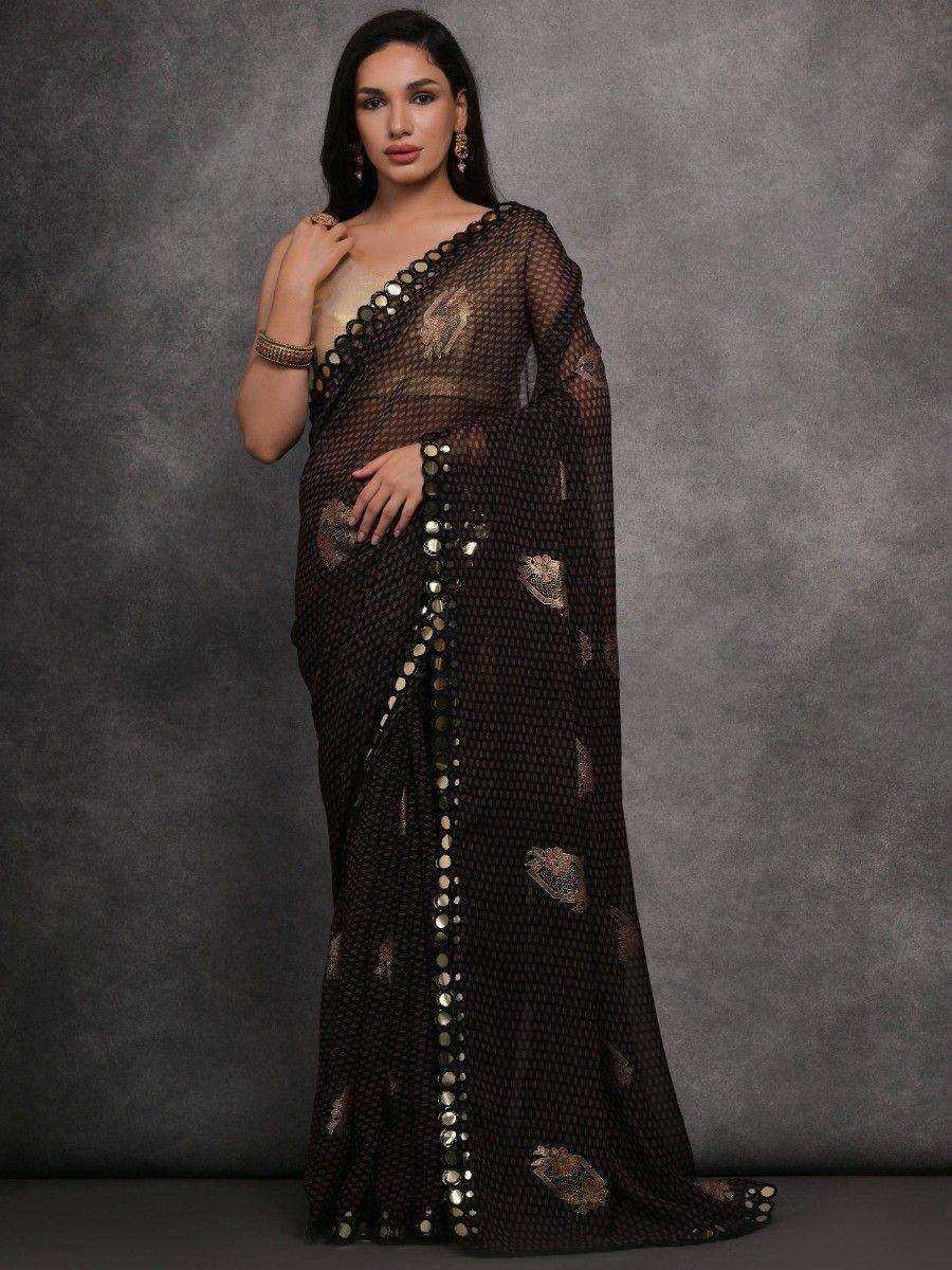Black sheer saree with gold mirror work and floral embroidery, styled with gold jewelry for ethnic wear