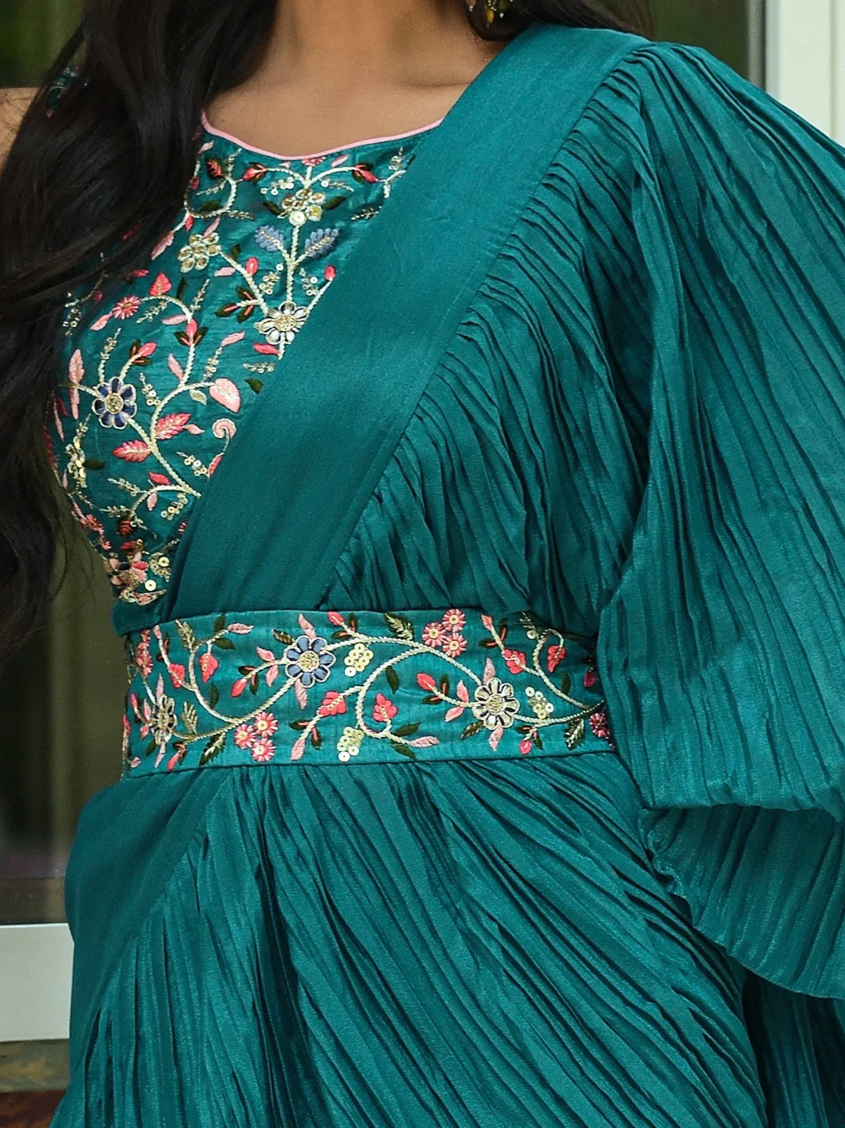 Teal ethnic gown with floral embroidery and pleated sleeves, perfect for Indian occasions