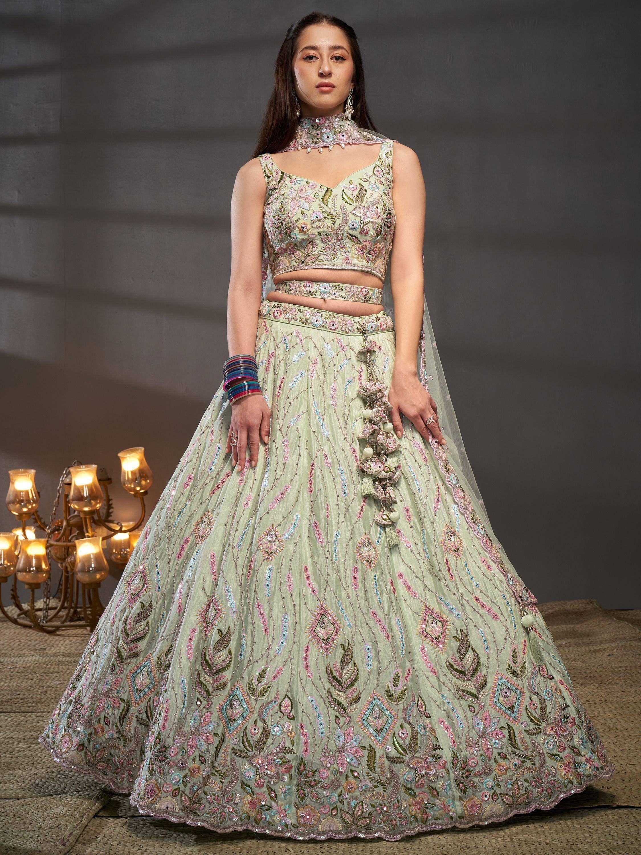 Mint green embroidered lehenga choli with floral motifs, perfect for weddings and festive occasions.