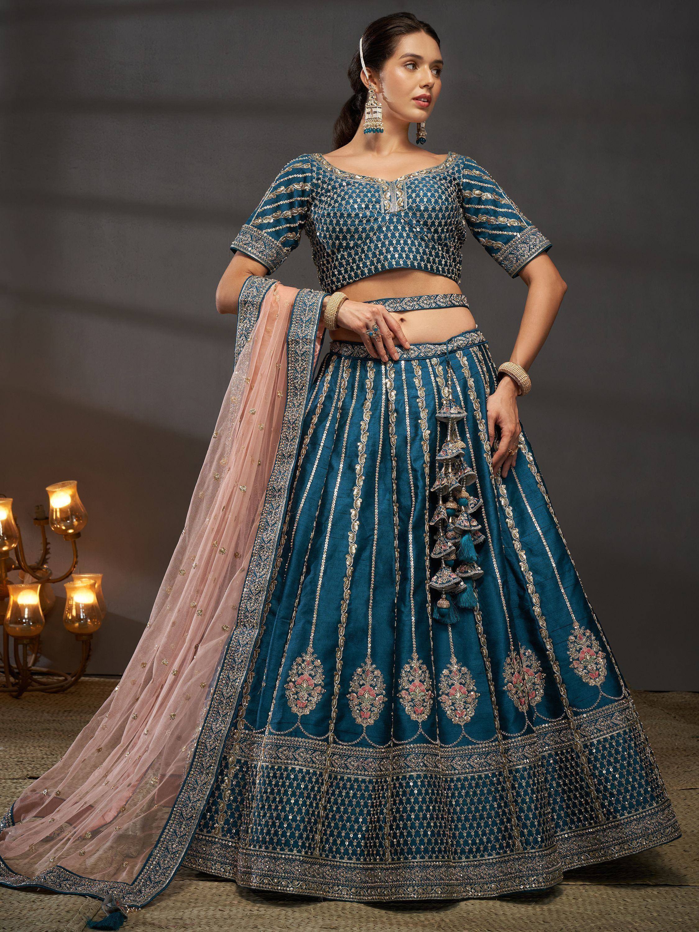 Teal blue embroidered lehenga choli with pink dupatta, perfect for Indian ethnic wear events.