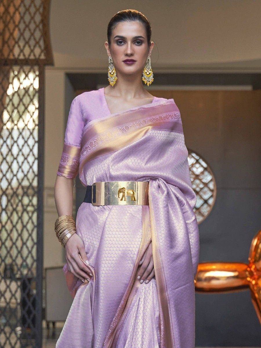 Lavender silk saree with gold border, elephant belt, and statement earrings for Indian ethnic wear