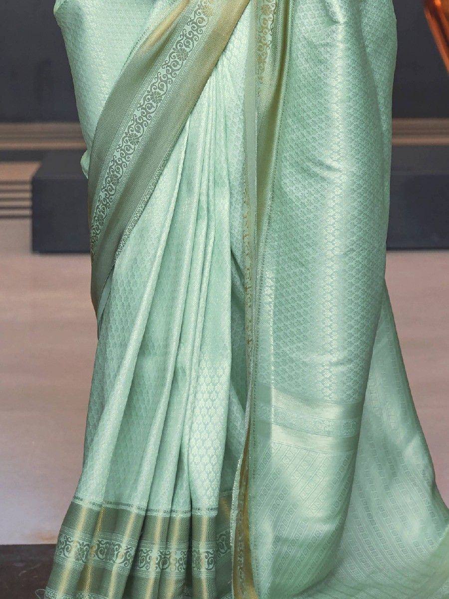 Mint green designer saree with gold zari border and intricate woven patterns, perfect for ethnic occasions