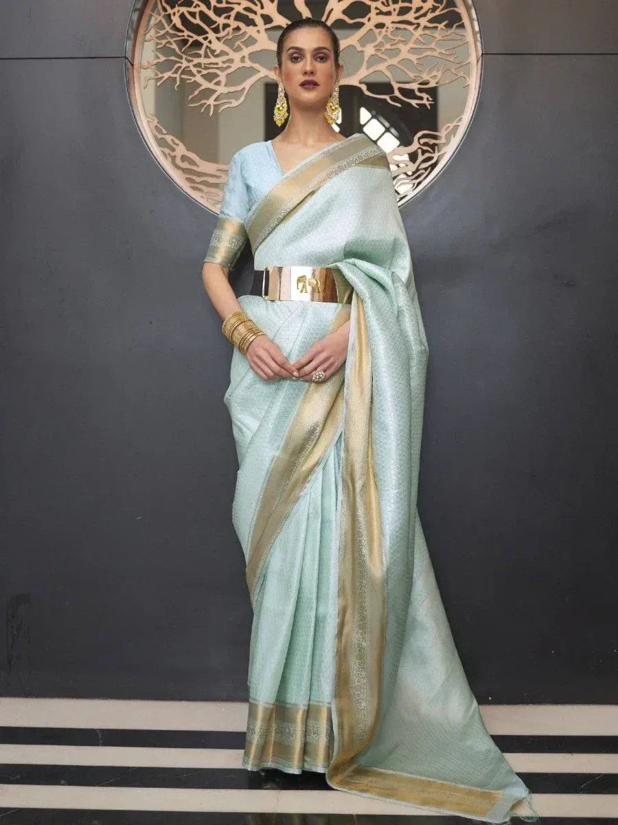 Light blue designer saree with gold border, paired with matching blouse and statement belt for ethnic wear