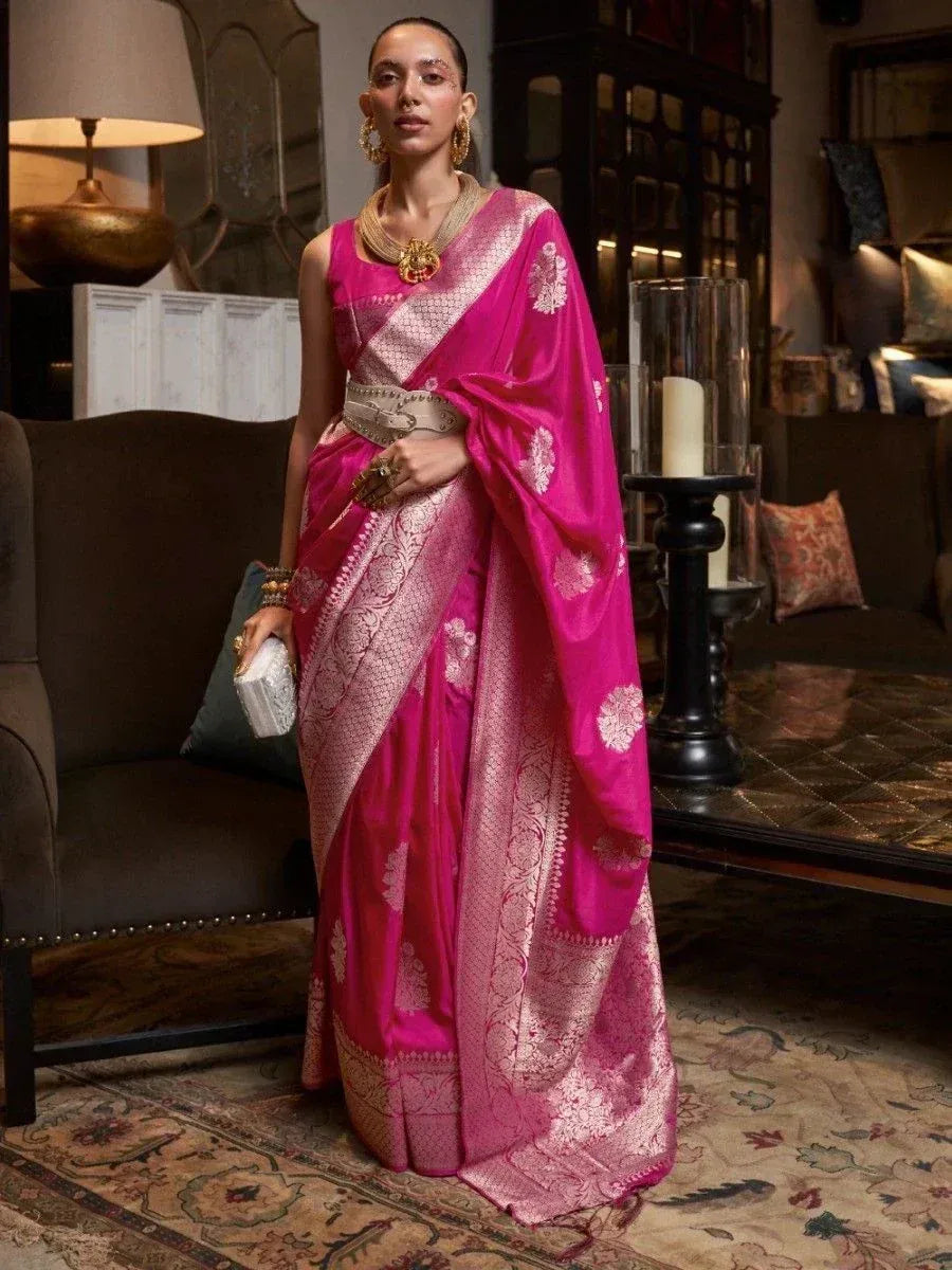 Vibrant pink silk saree with gold floral embroidery, styled with statement jewelry for ethnic occasions