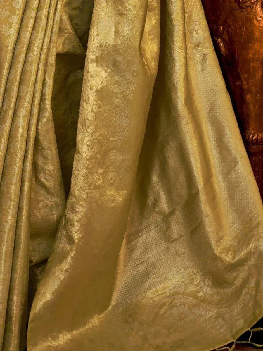 Luxury golden brocade fabric with intricate floral patterns, ideal for designer ethnic wear and sarees.