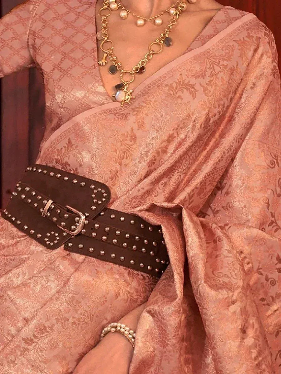 Pink designer saree with gold embroidery, studded belt, and pearl jewelry for ethnic wear