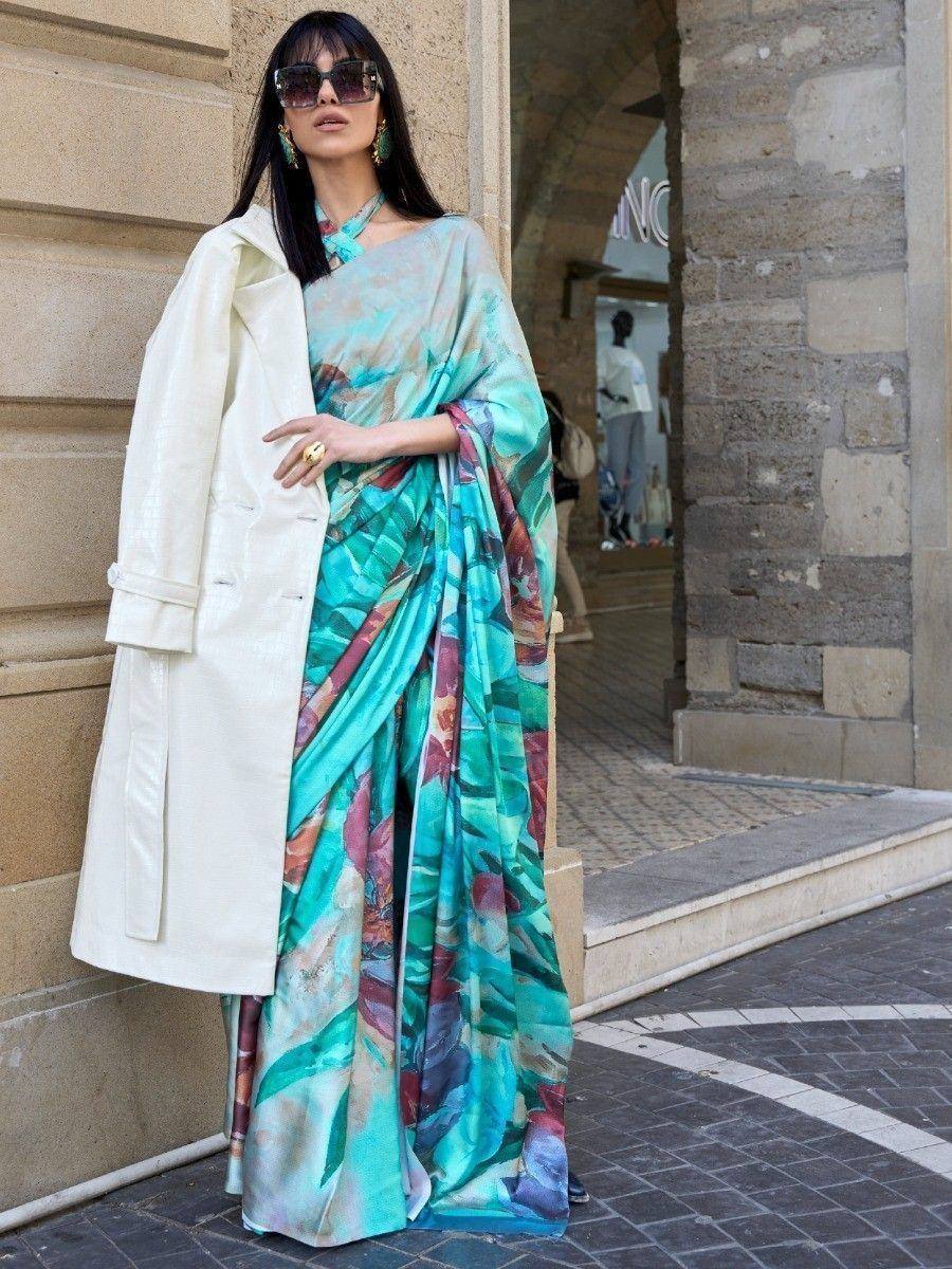 Woman in vibrant printed saree with white coat, stylish ethnic wear for modern occasions