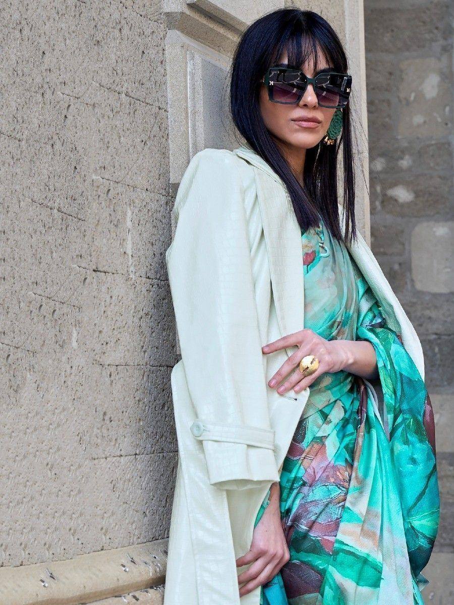 Woman in floral saree with cream coat, stylish ethnic wear for modern occasions