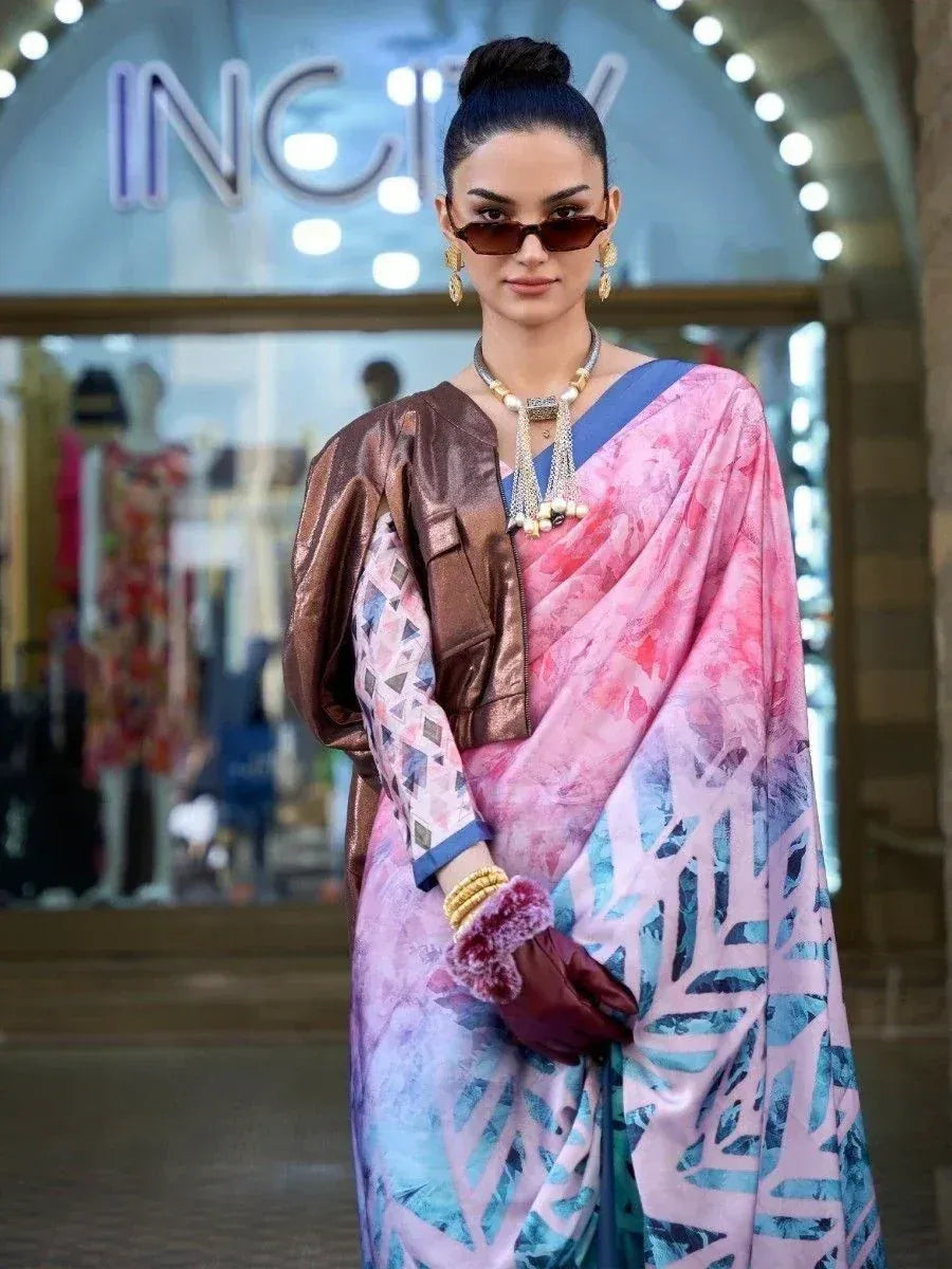Stylish woman in pink and blue printed saree with metallic jacket, sunglasses, and statement jewelry