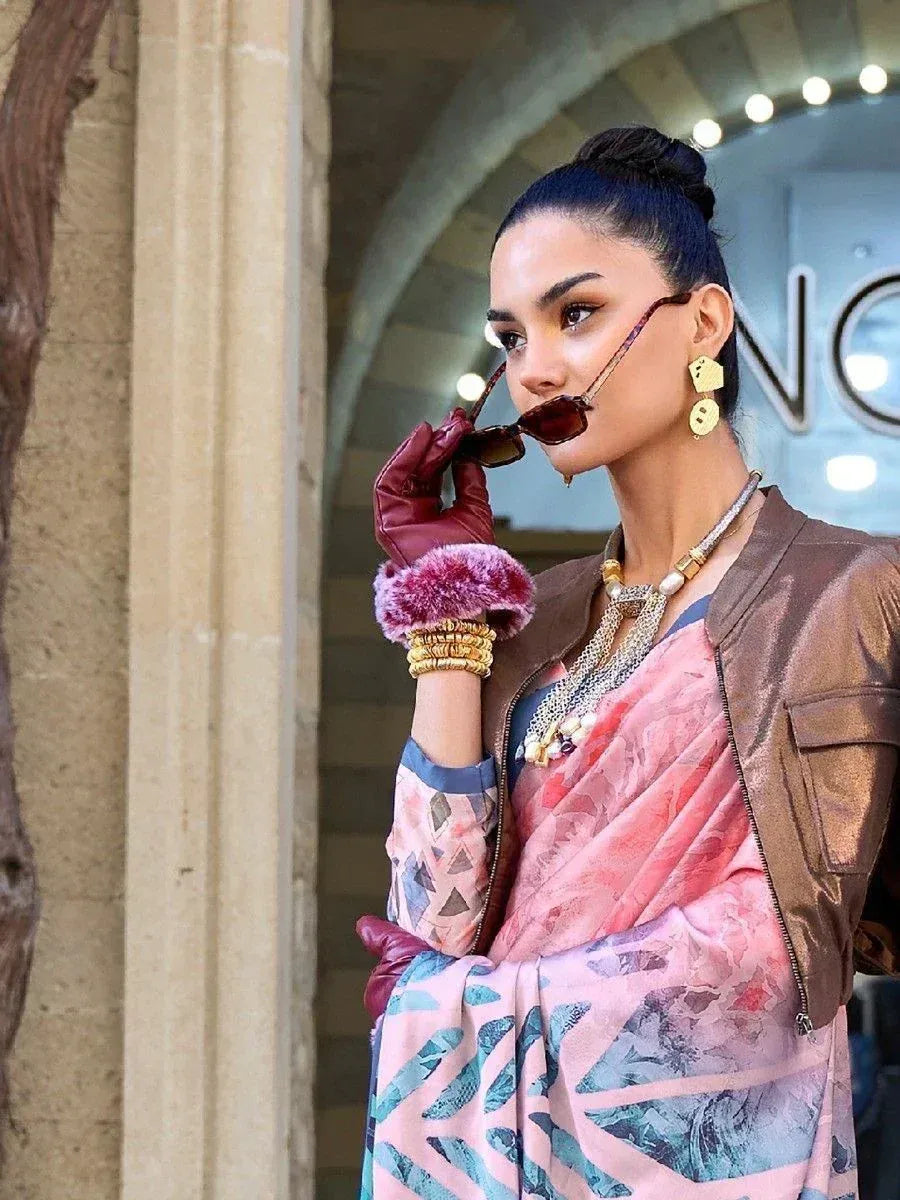 Stylish woman in printed saree with leather jacket, statement jewelry, and gloves — modern ethnic fashion
