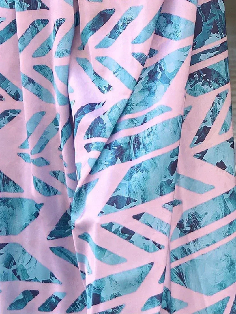Pink and teal abstract print ethnic gown fabric close-up