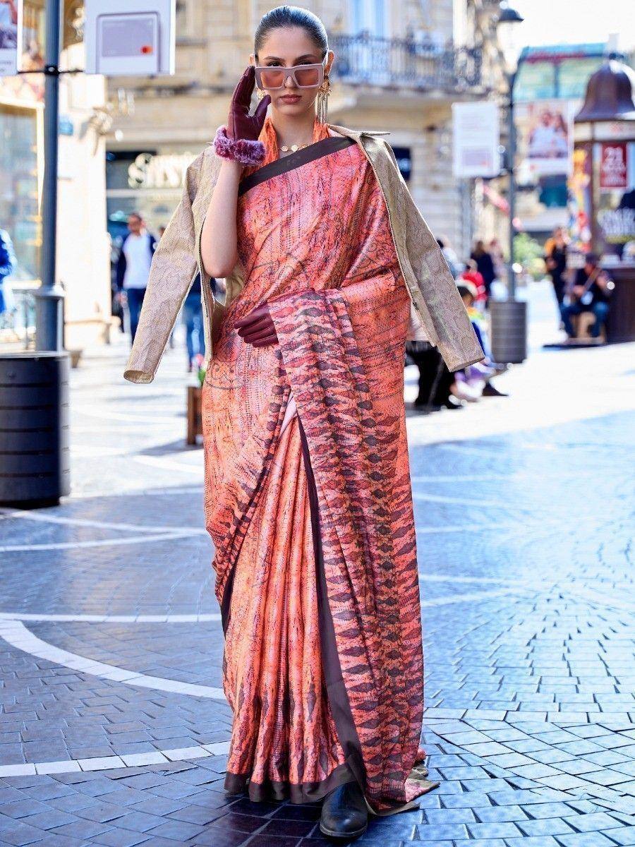 Woman in trendy orange printed saree with gold jacket, stylish ethnic wear for modern occasions