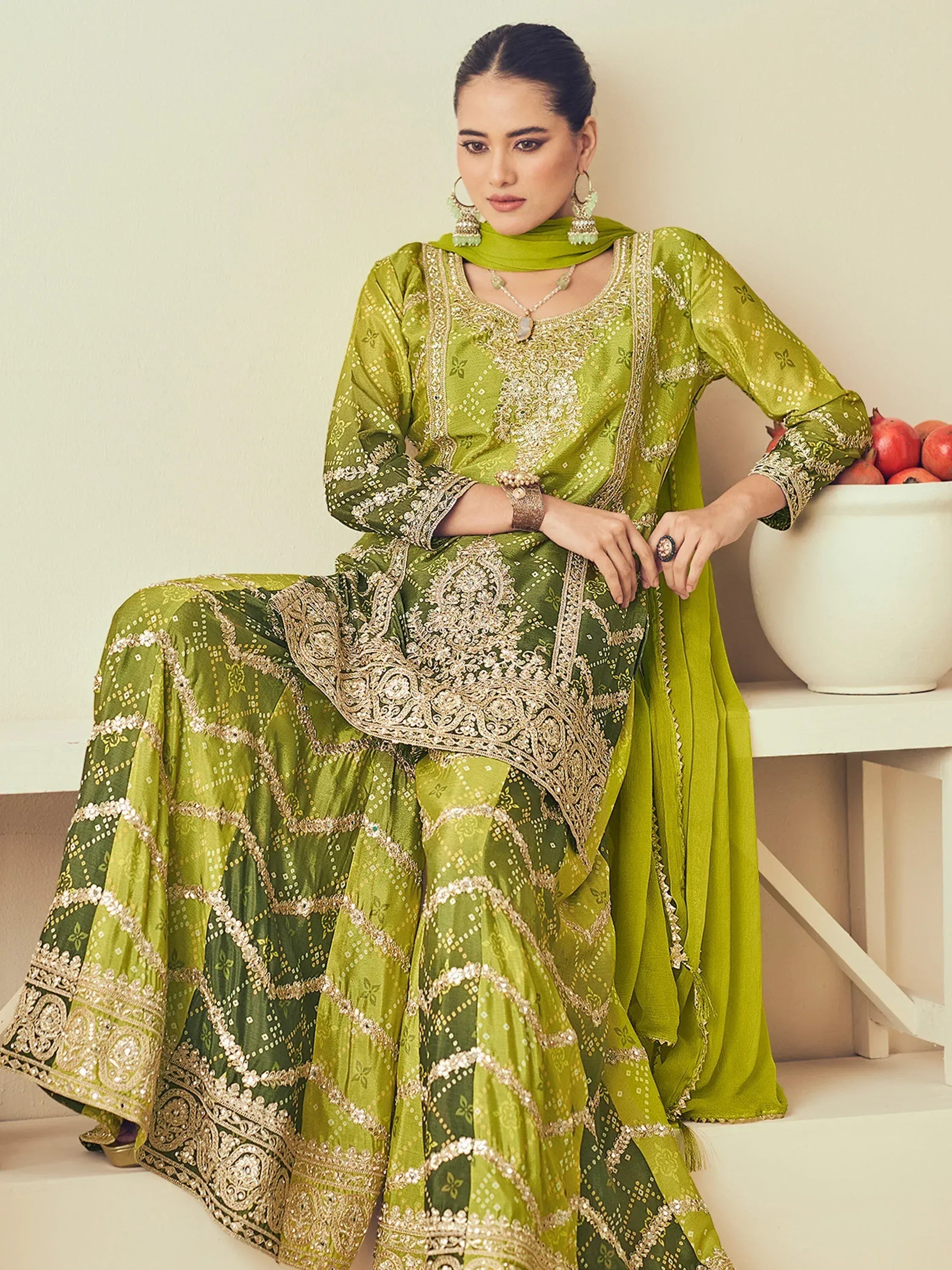 Green embroidered salwar kameez with gold detailing, perfect for ethnic occasions
