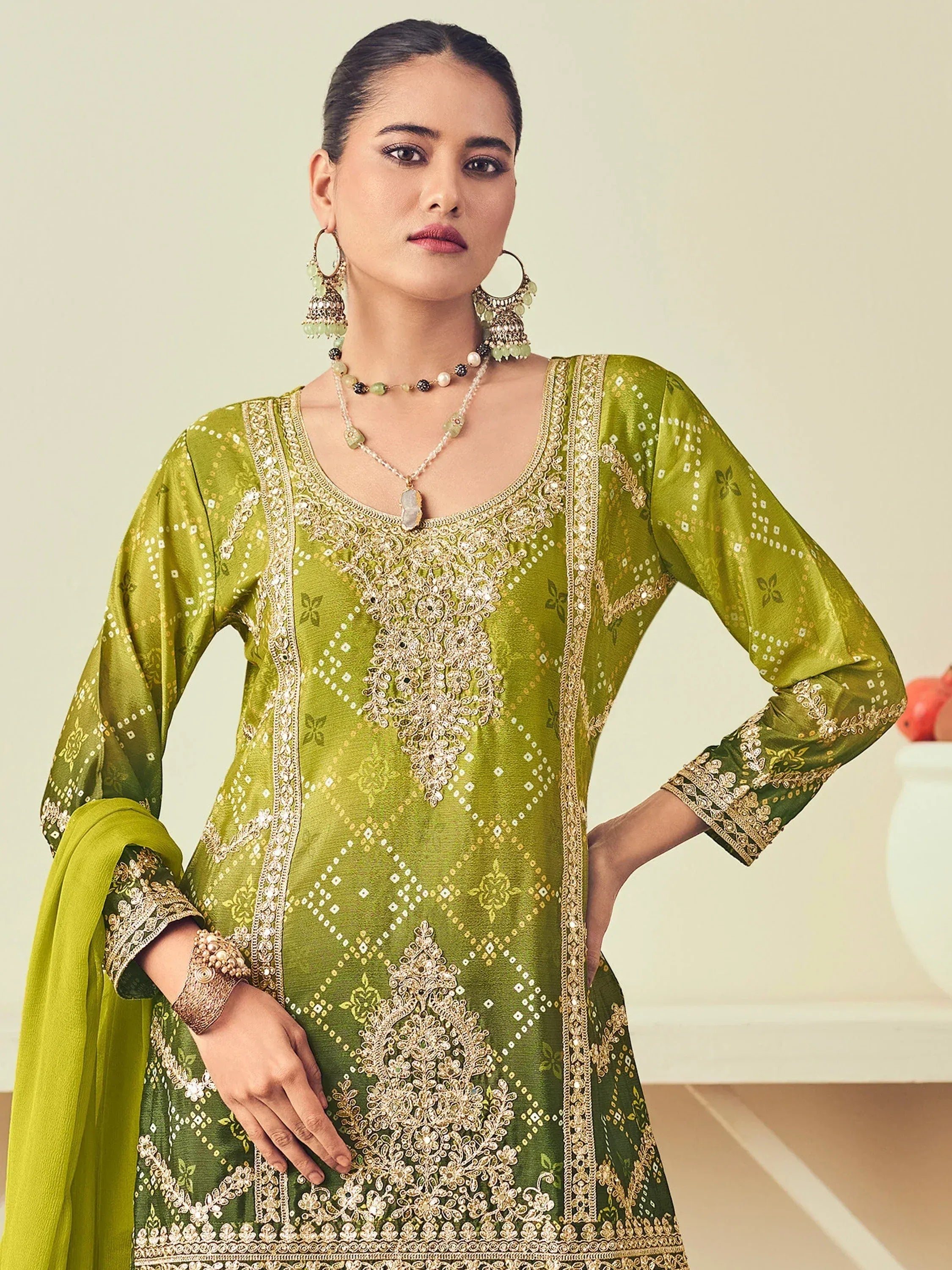Green embroidered salwar kameez with gold detailing, perfect for Indian ethnic wear occasions
