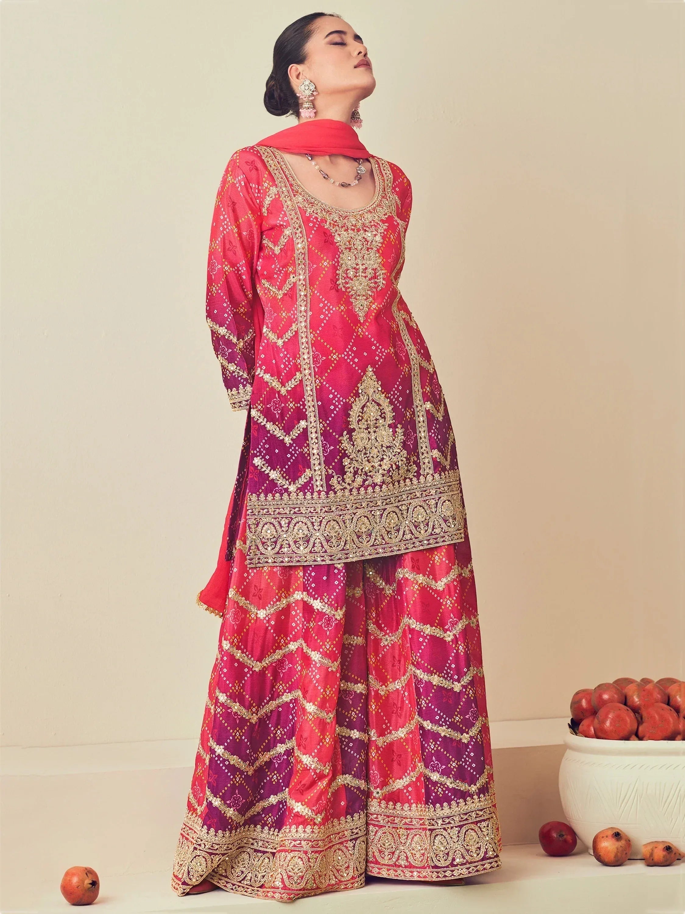 Pink and purple embroidered salwar kameez with gold detailing, perfect for Indian ethnic wear occasions.