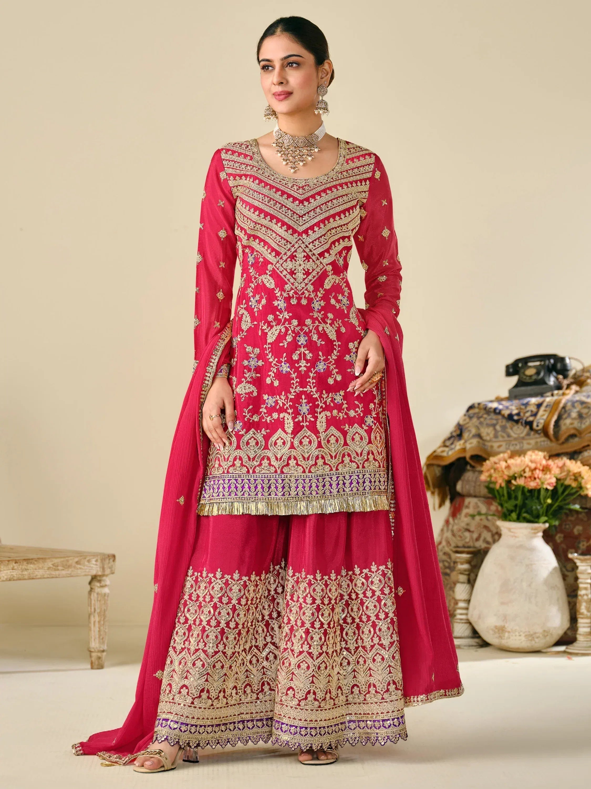 Elegant red ethnic salwar kameez with gold embroidery, perfect for Indian weddings and festive occasions.