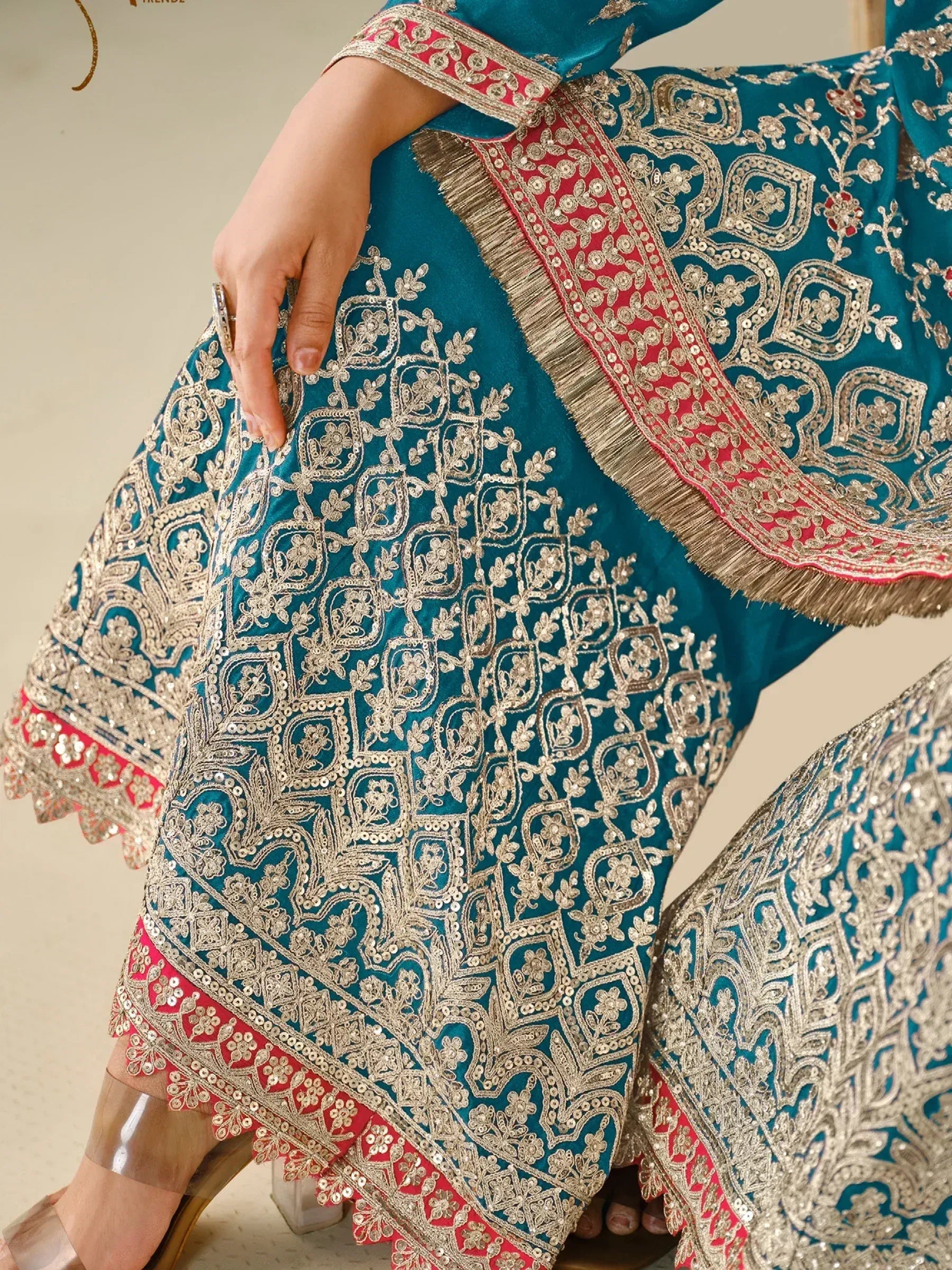 Teal designer lehenga choli with gold embroidery and red border, ethnic Indian wear