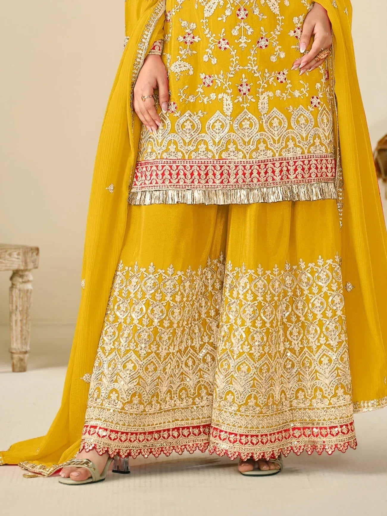 Yellow embroidered salwar kameez with red and gold detailing, perfect for Indian ethnic wear occasions
