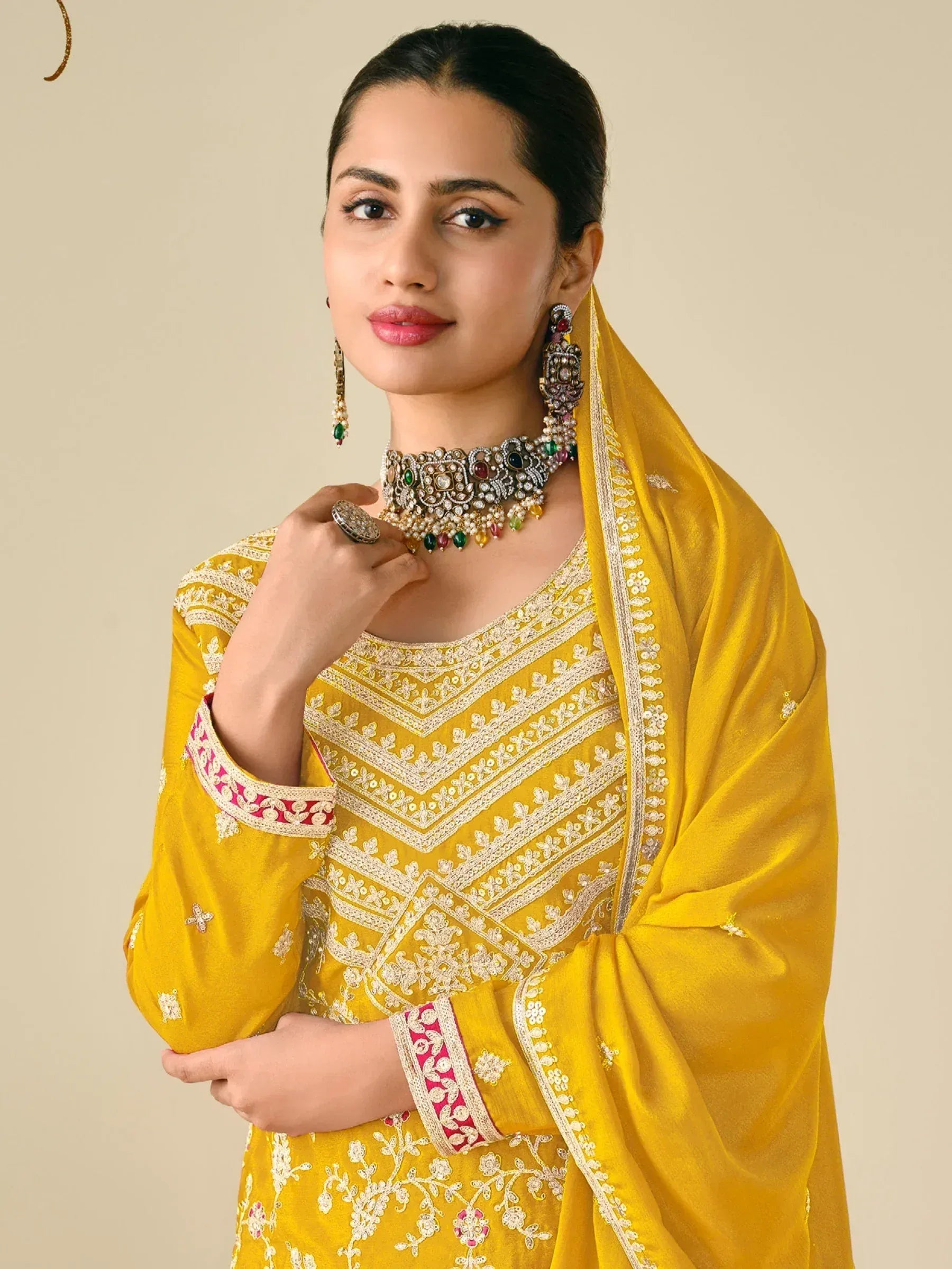 Yellow embroidered salwar kameez with dupatta, paired with traditional jewelry for Indian ethnic wear