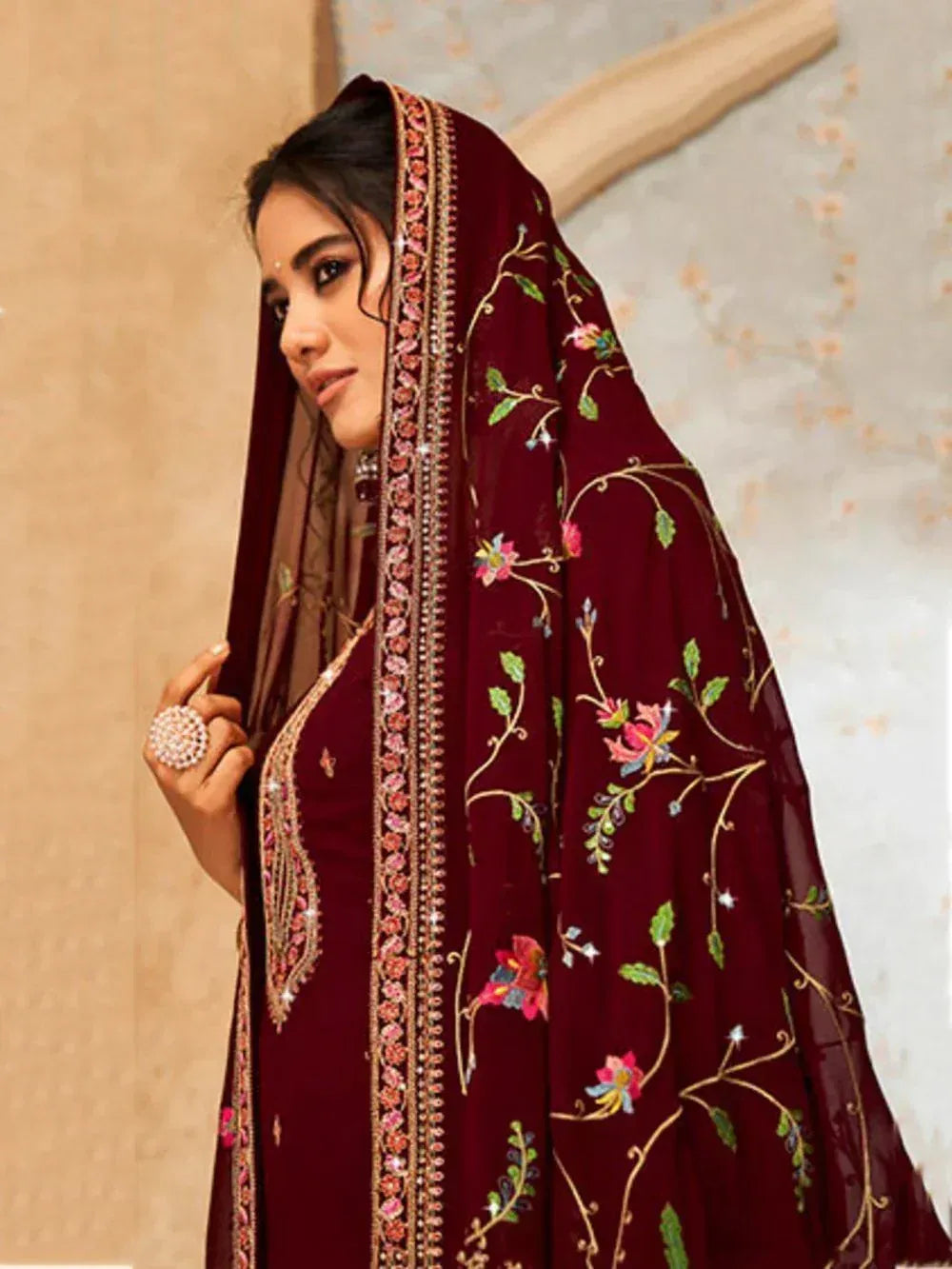 Woman in maroon embroidered salwar kameez with floral dupatta, traditional Indian ethnic wear