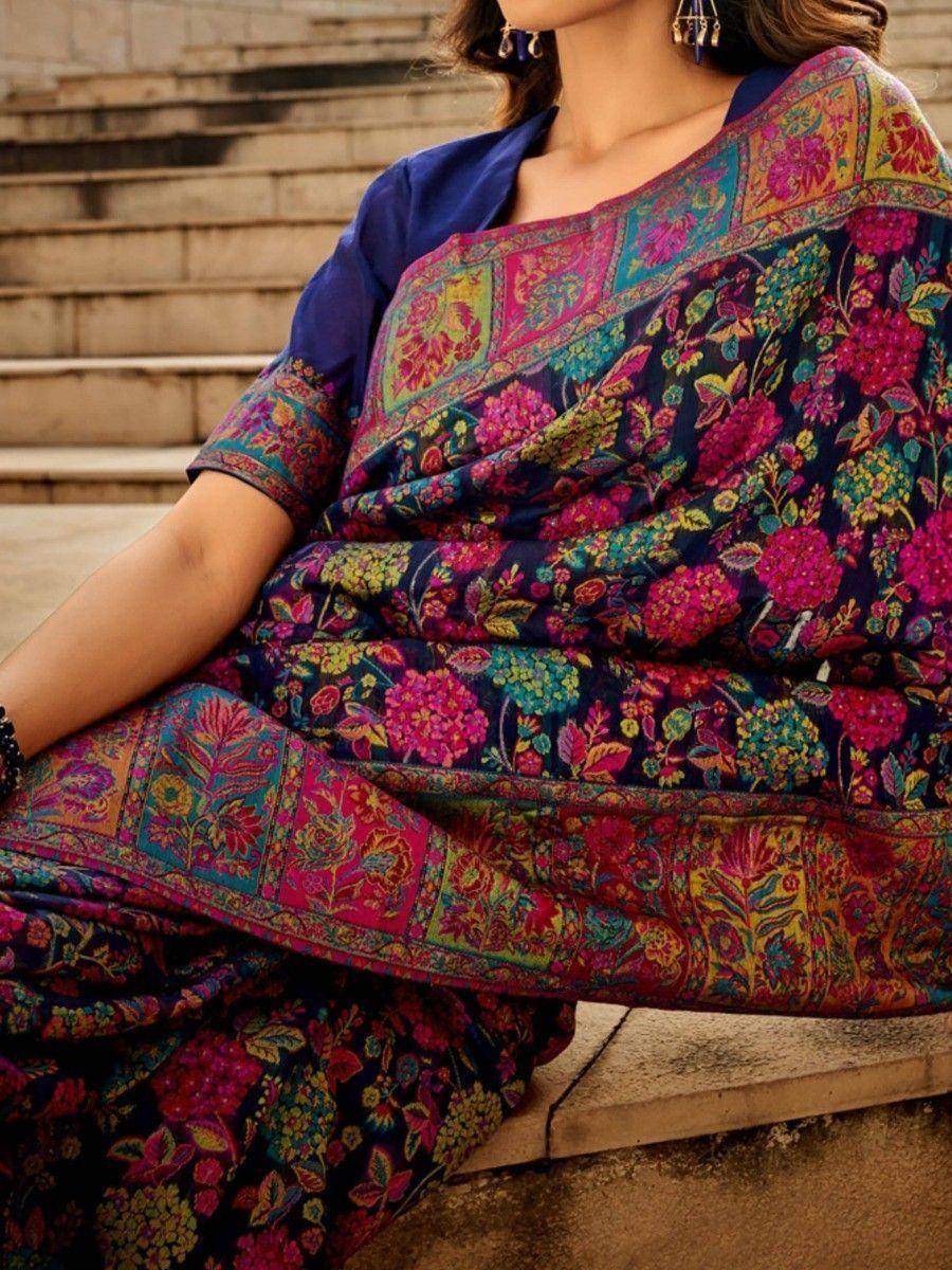 Vibrant floral printed saree with rich border, paired with navy blue blouse, perfect for ethnic occasions.