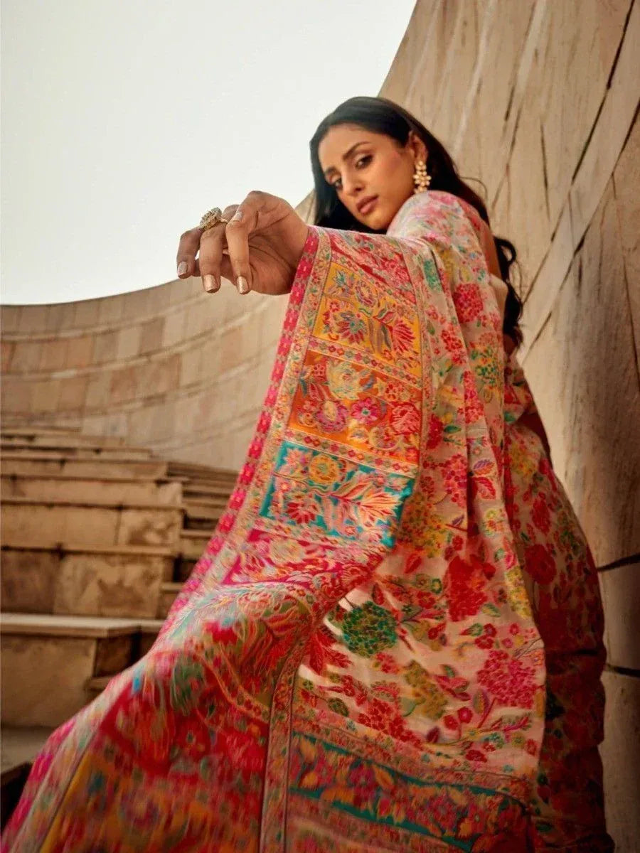 Woman in vibrant floral printed saree with colorful border, styled for ethnic occasions