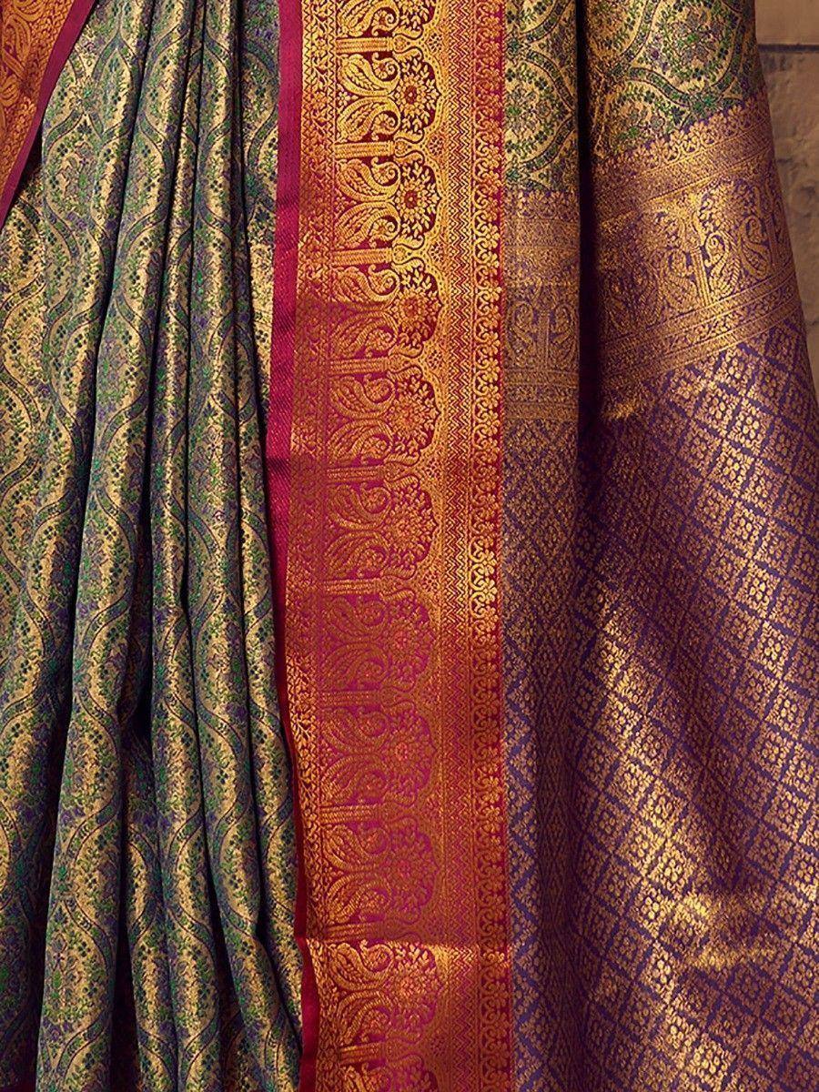 Luxury Indian saree with intricate gold zari, paisley & geometric patterns in green, purple, and red