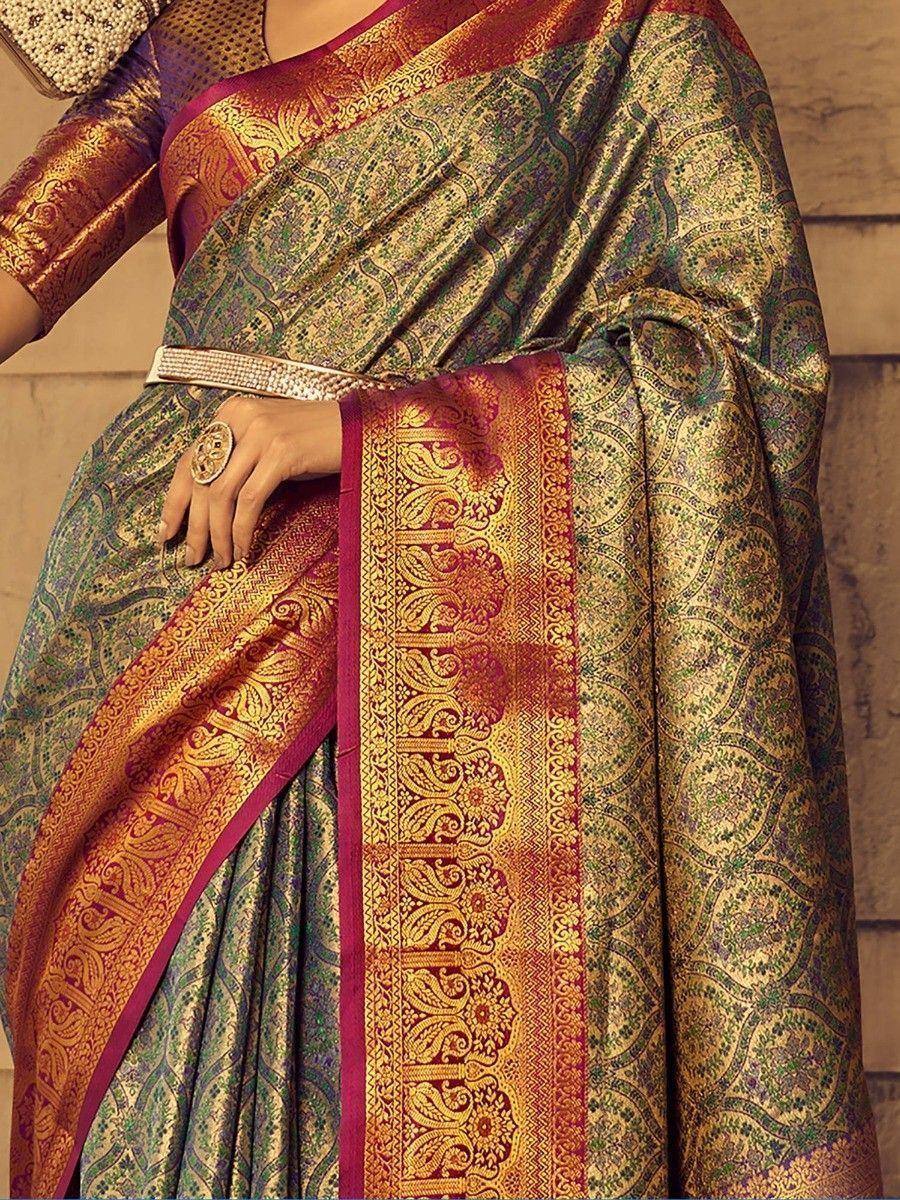 Elegant Indian saree with gold paisley print, rich maroon border, and designer blouse for festive occasions
