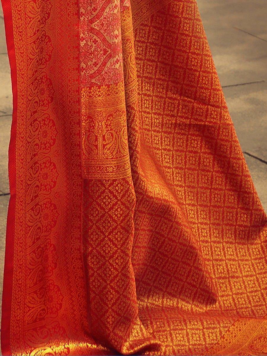 Red and gold ethnic saree with intricate paisley and geometric woven patterns, perfect for festive occasions.