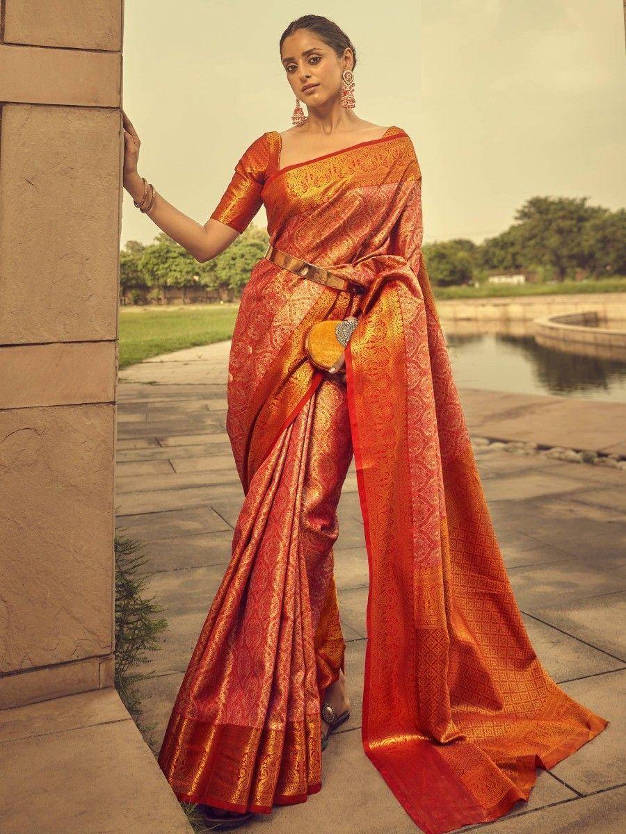 Elegant orange and gold designer saree with intricate patterns, perfect for Indian ethnic occasions